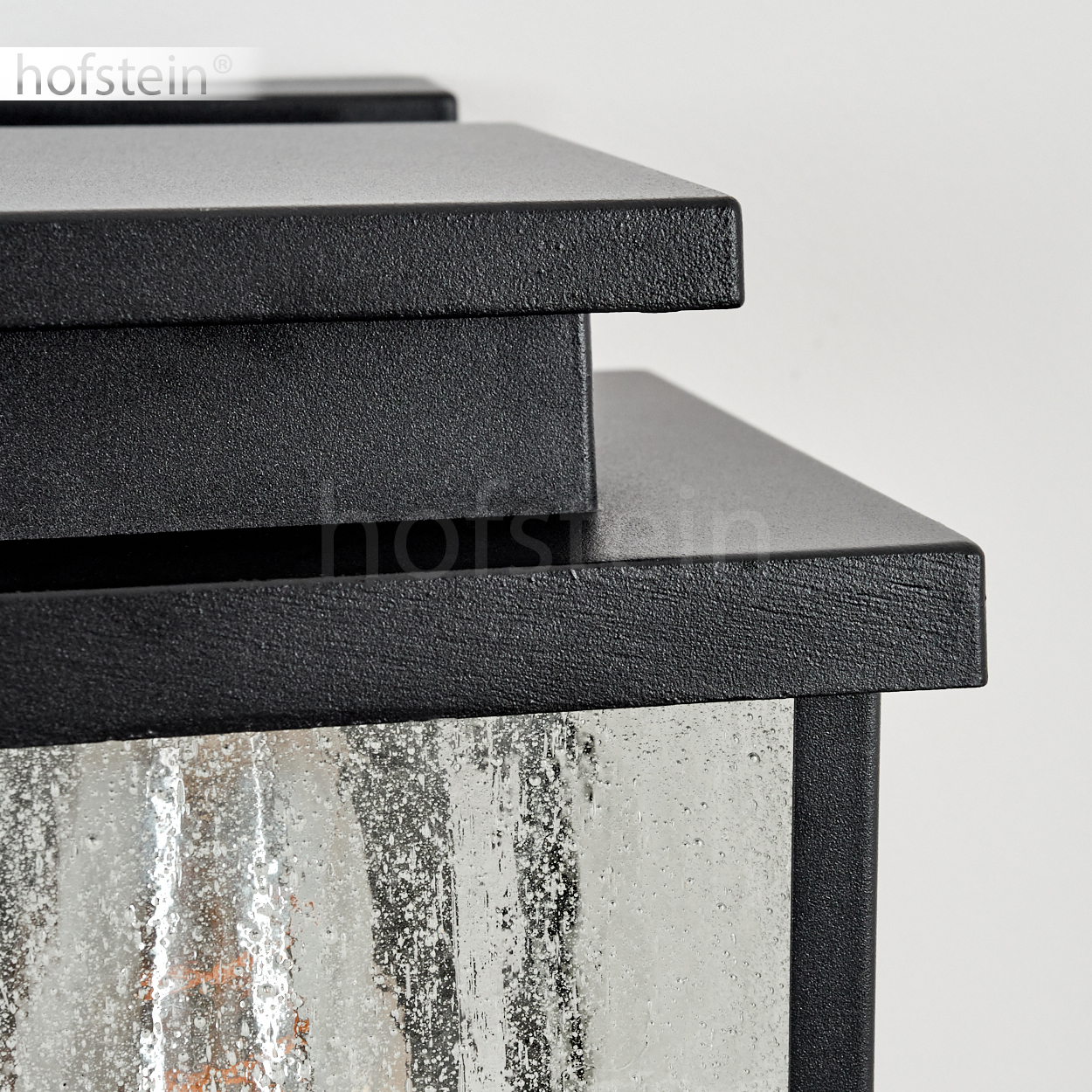 Schwarze Laterne mit strukturiertem Glas und Metalloberseite.