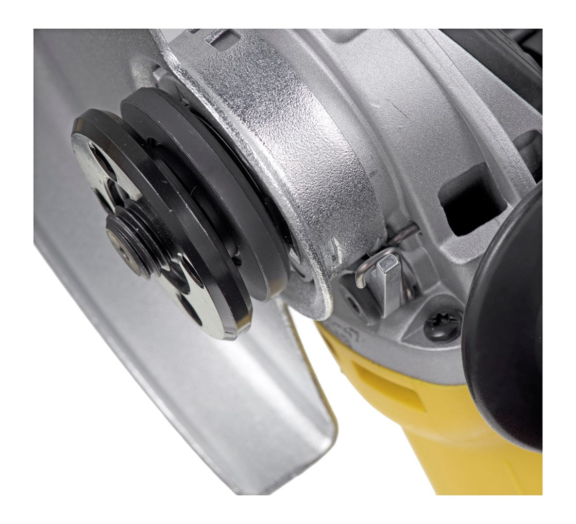 Close-up of an angle grinder's metal disc and motor housing, with yellow accents.