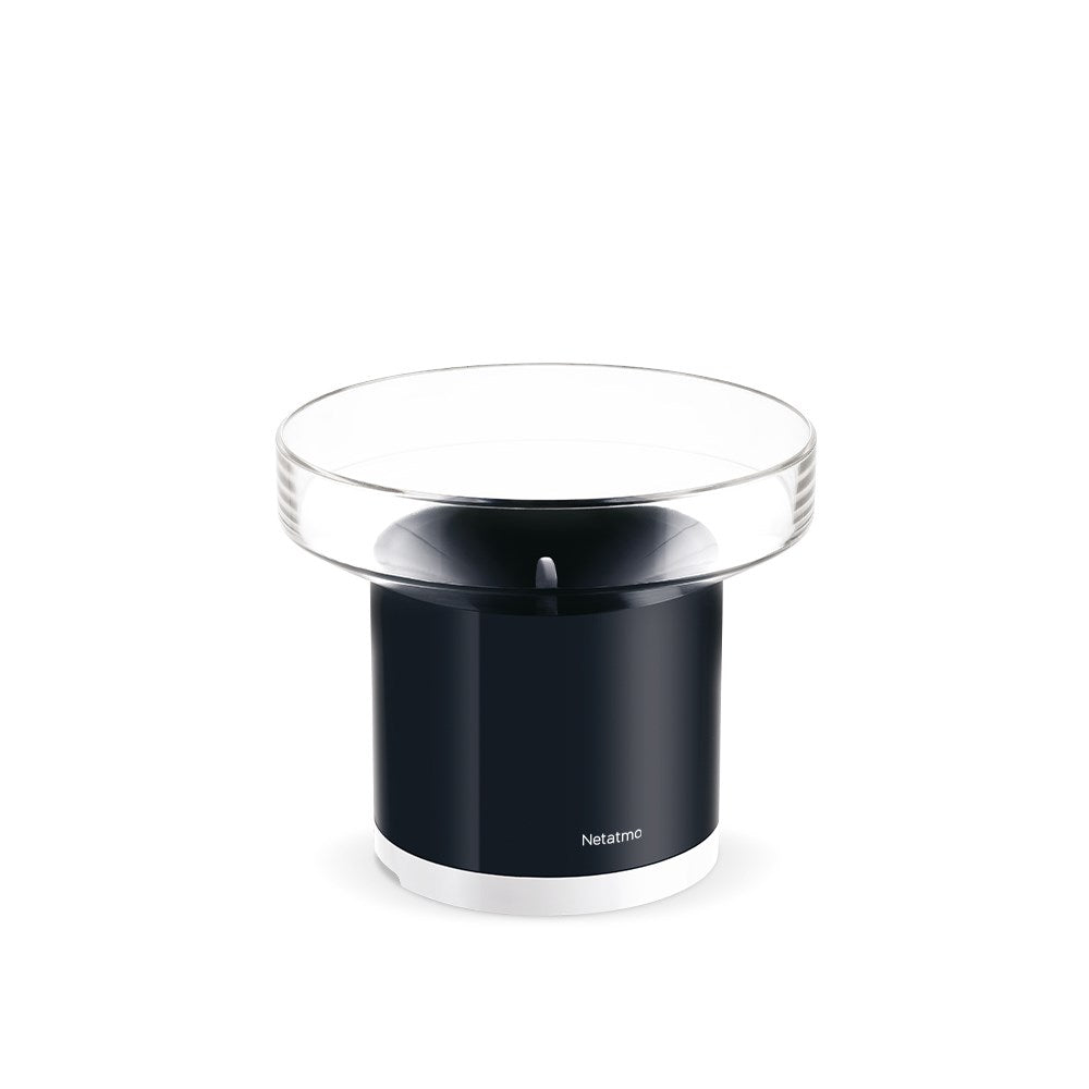 A black rain gauge with a glass top.