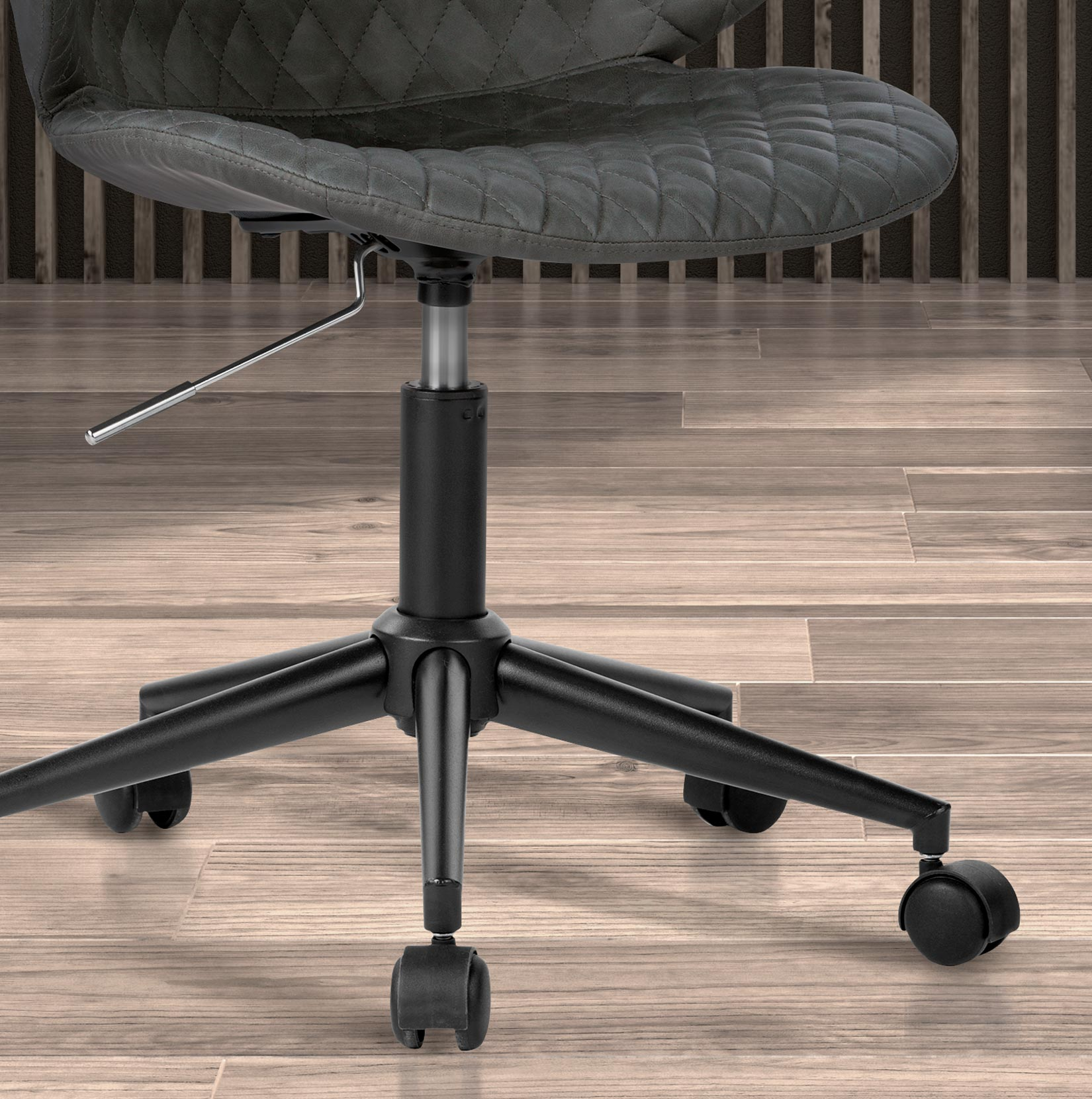 Silla de oficina gris con ruedas sobre suelo de madera.