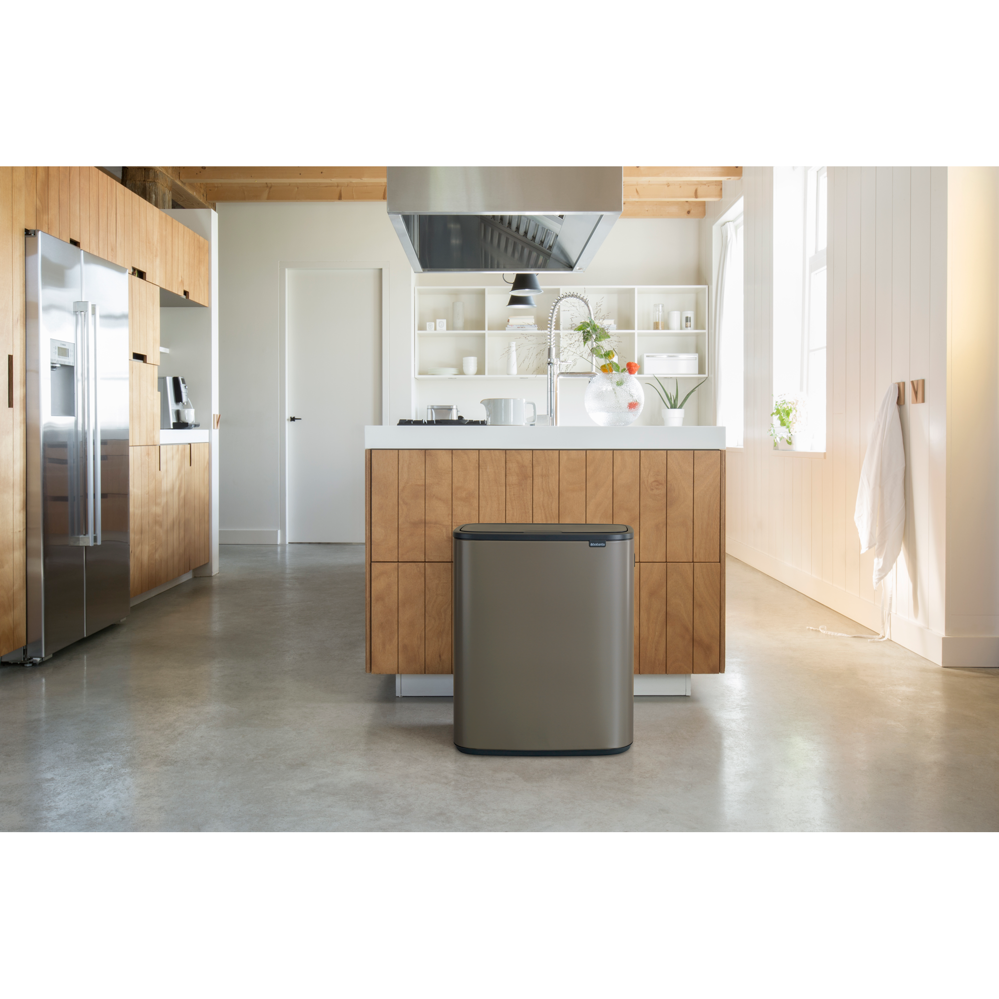 Moderne keuken met roestvrijstalen koelkast en houten kasten.