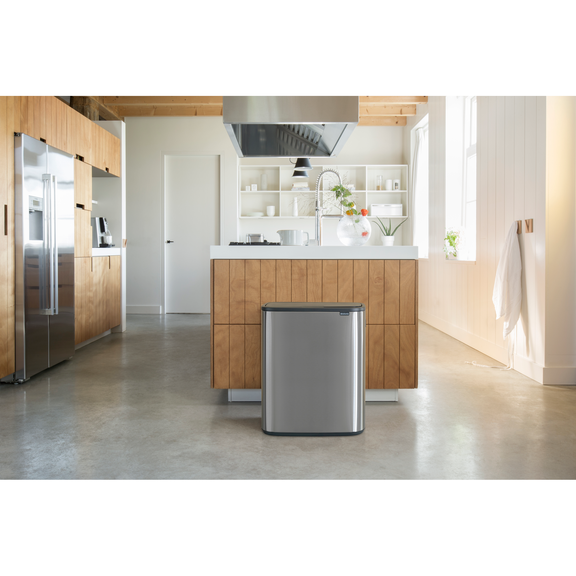 Moderne keuken met roestvrijstalen prullenbak en houten accenten.