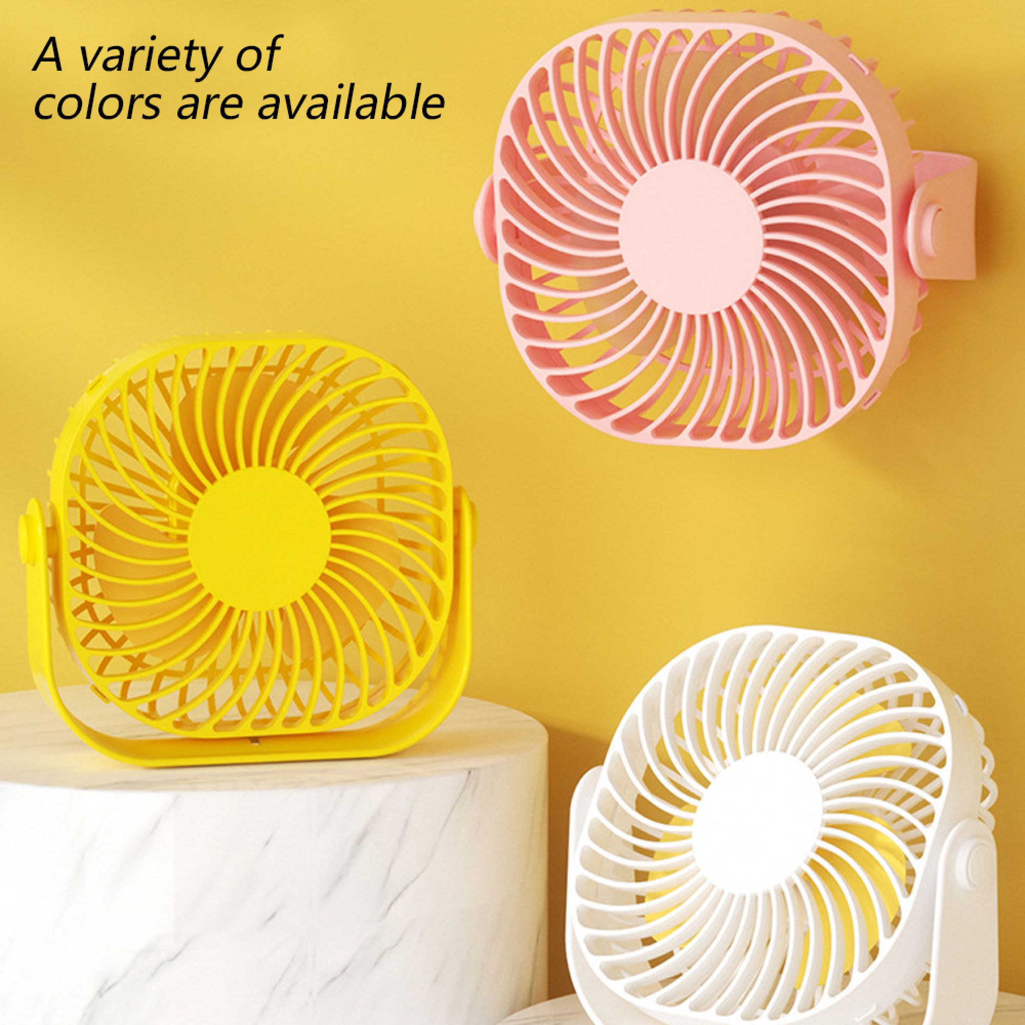 Drei kleine Ventilatoren: gelb, rosa und weiß mit gelben Blättern.