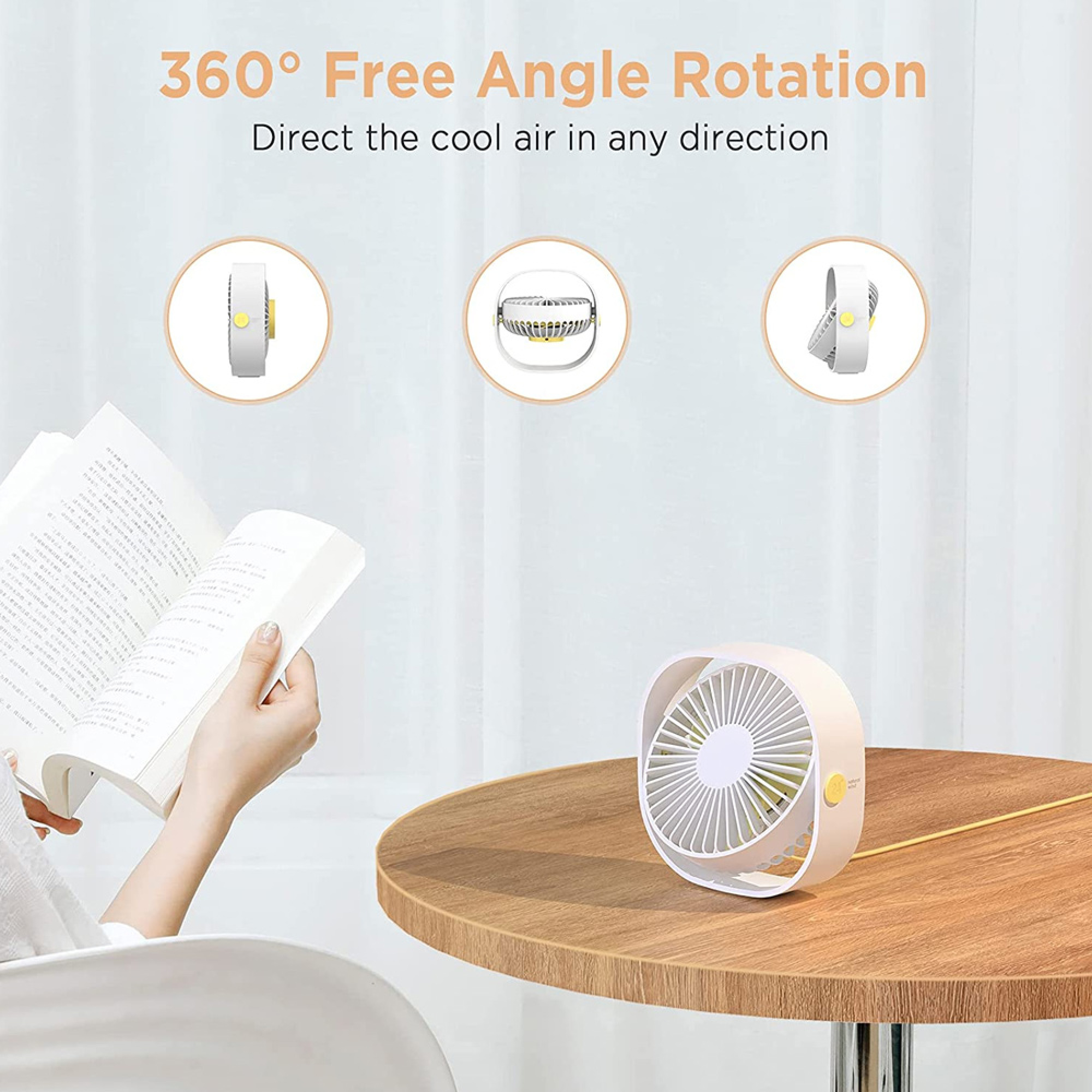 Ein kleiner weißer Ventilator steht auf einem Holztisch neben einer lesenden Person.