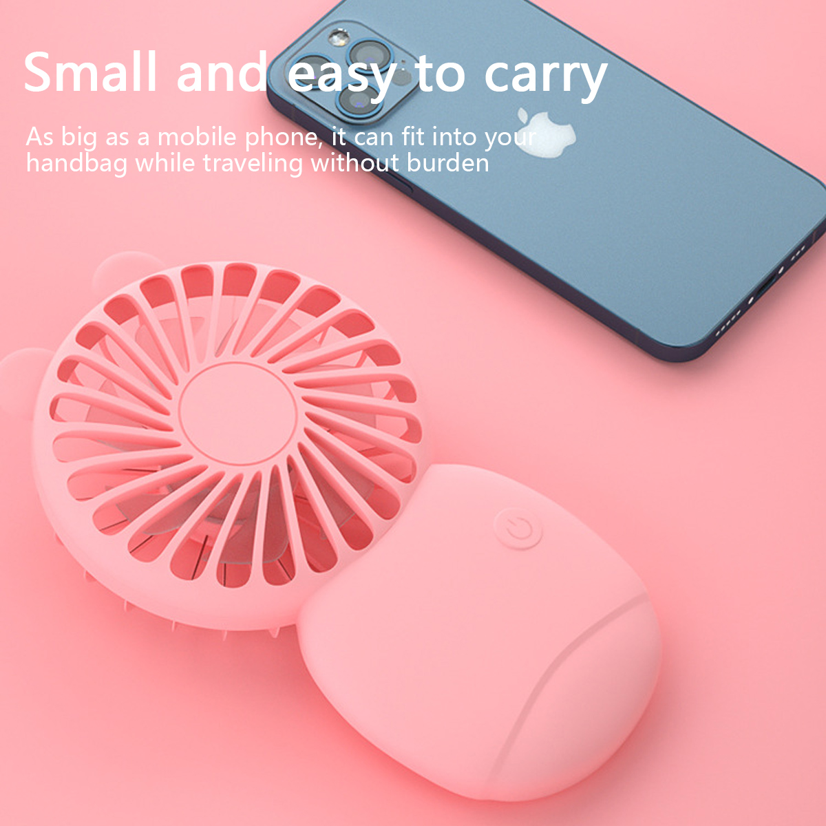 Ein rosa Ventilator und ein blaues Smartphone liegen auf einem rosa Hintergrund.