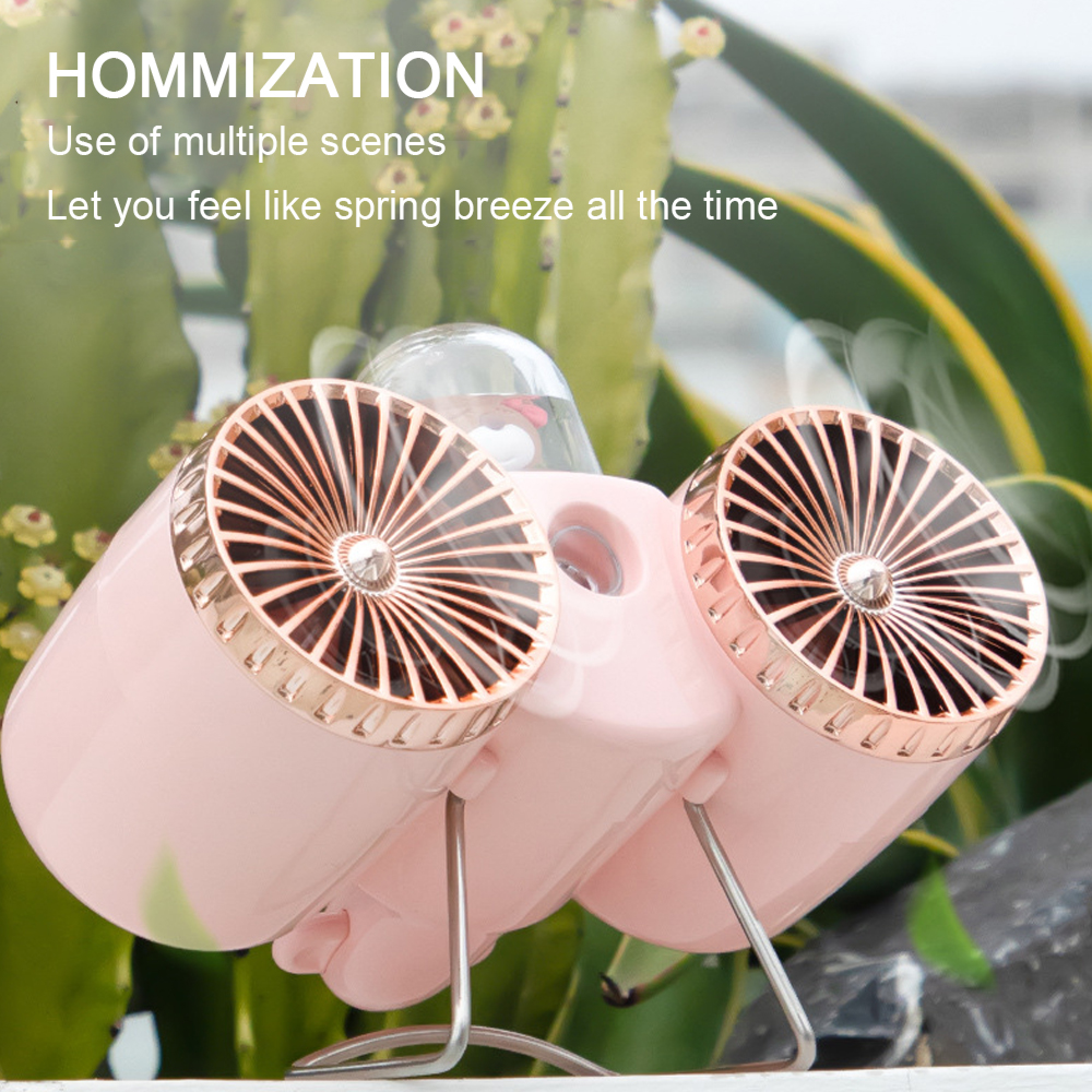 Ein kleiner rosa Ventilator mit zwei Lüftern und goldenen Akzenten steht vor Pflanzen.