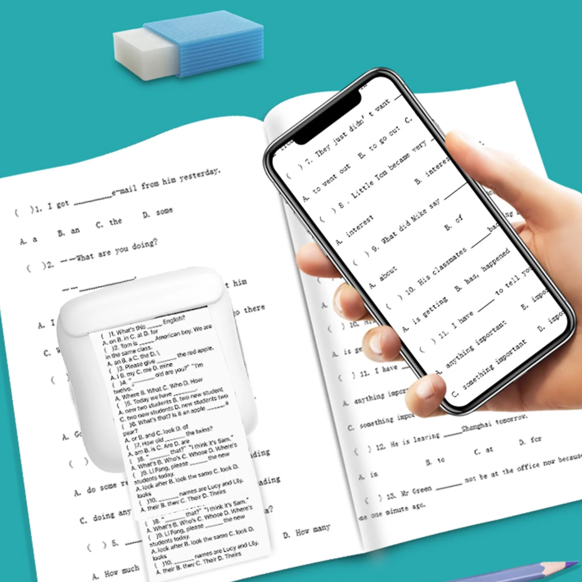 Ein Handy zeigt einen Test mit Lücken. Ein Drucker und Radiergummis liegen daneben.