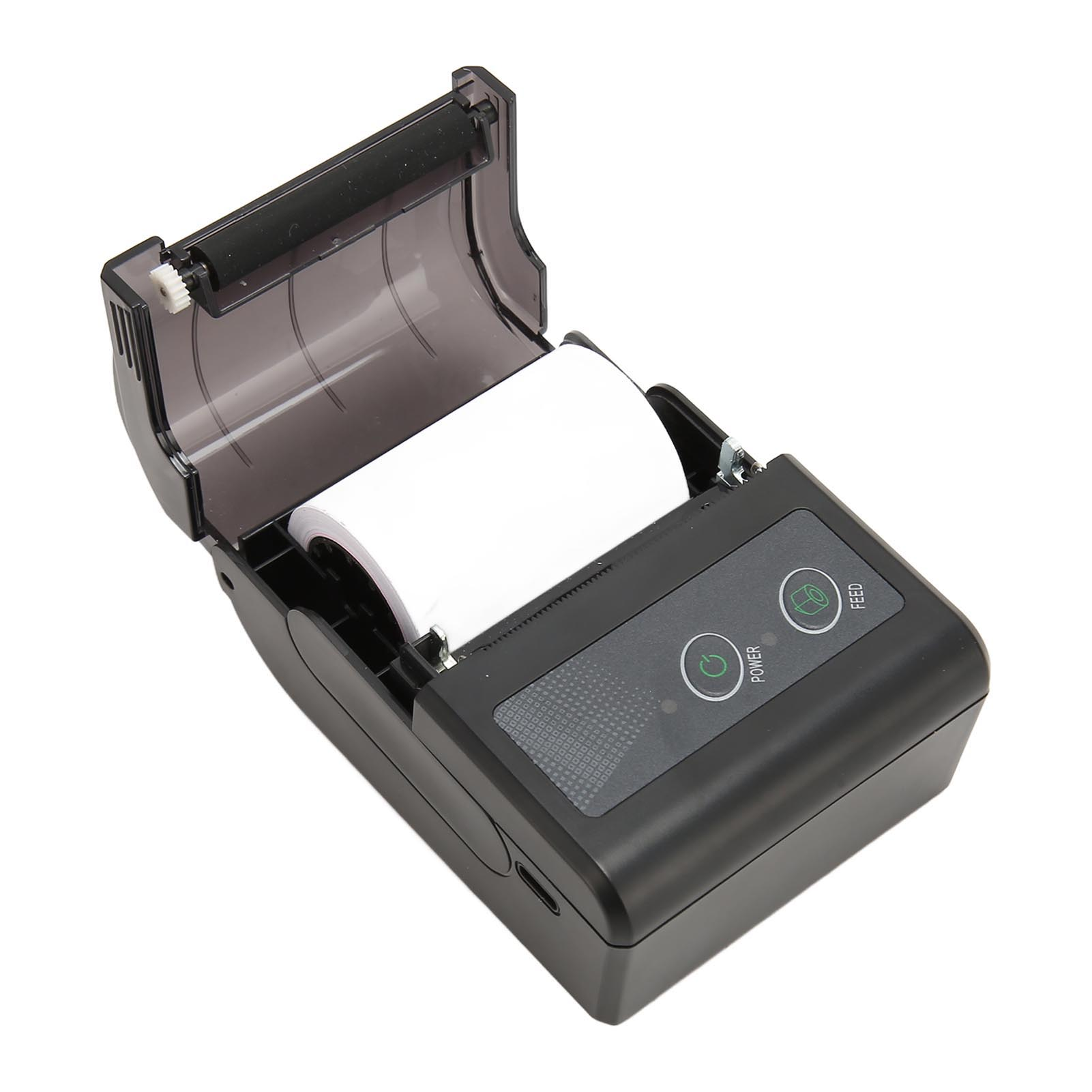 Ein schwarzer mobiler Drucker mit geöffnetem Deckel, der eine Papierrolle zeigt.