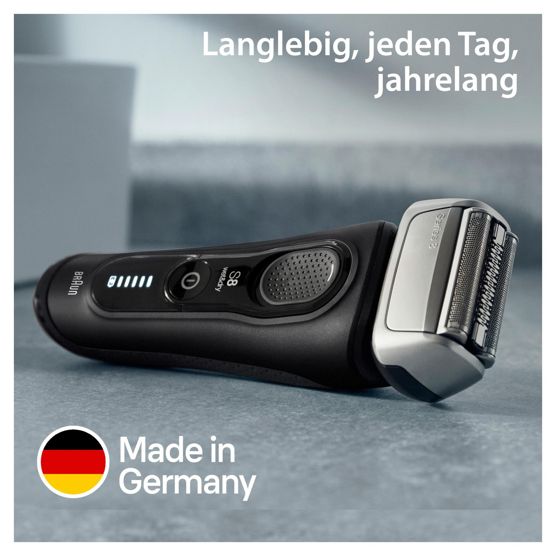 Ein schwarzer Braun Series 8 Elektrorasierer liegt auf einer grauen Oberfläche. Deutsche Flagge.