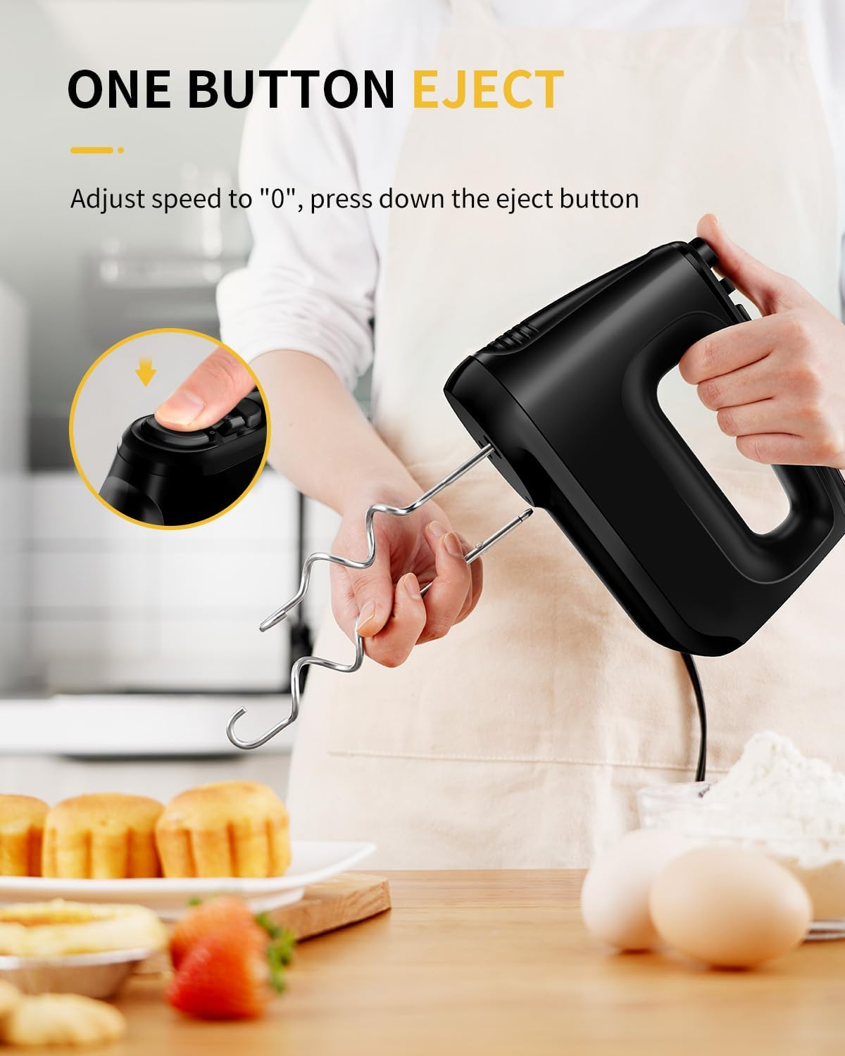 Schwarzer Handmixer mit Auswurftaste in der Nähe von Backwaren und Zutaten.