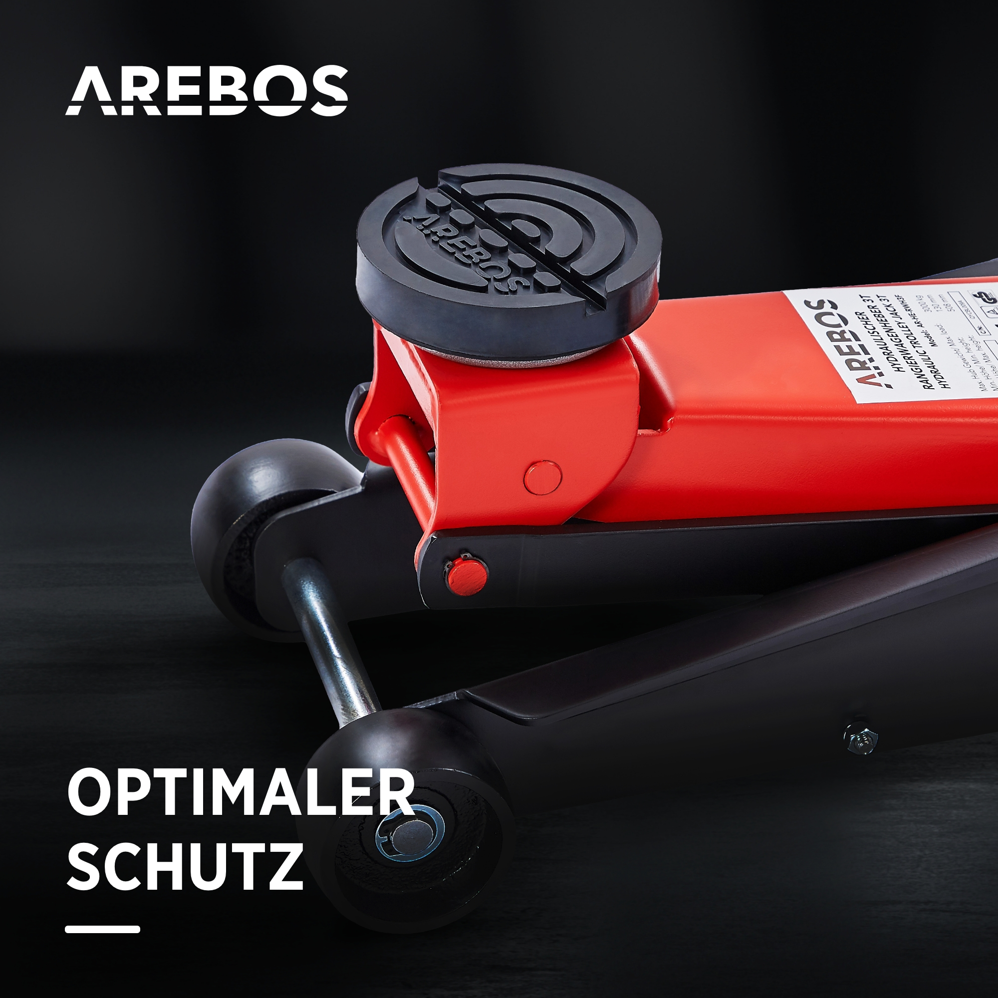 Ein roter hydraulischer Wagenheber mit schwarzem Sockel und Rädern.