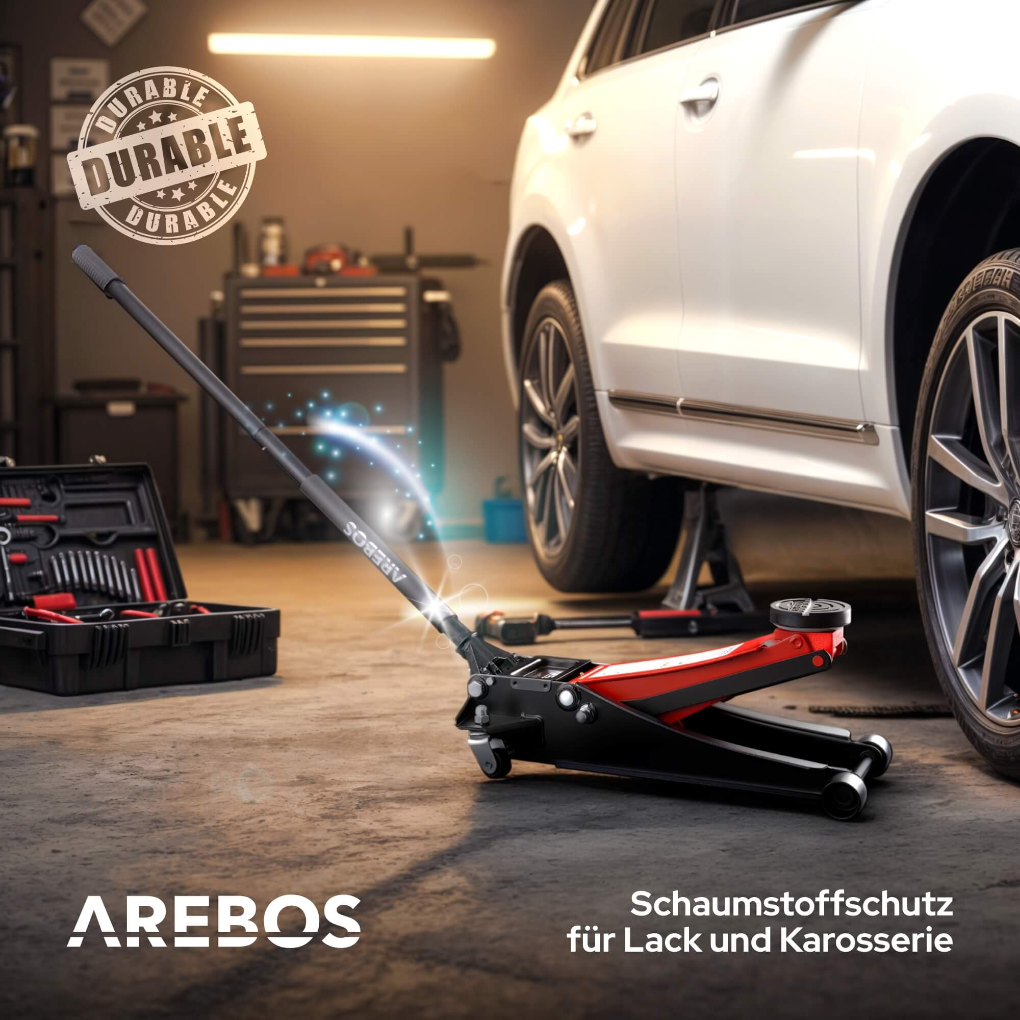 Ein roter und schwarzer Wagenheber neben einem Werkzeugkasten und einem weißen Auto.