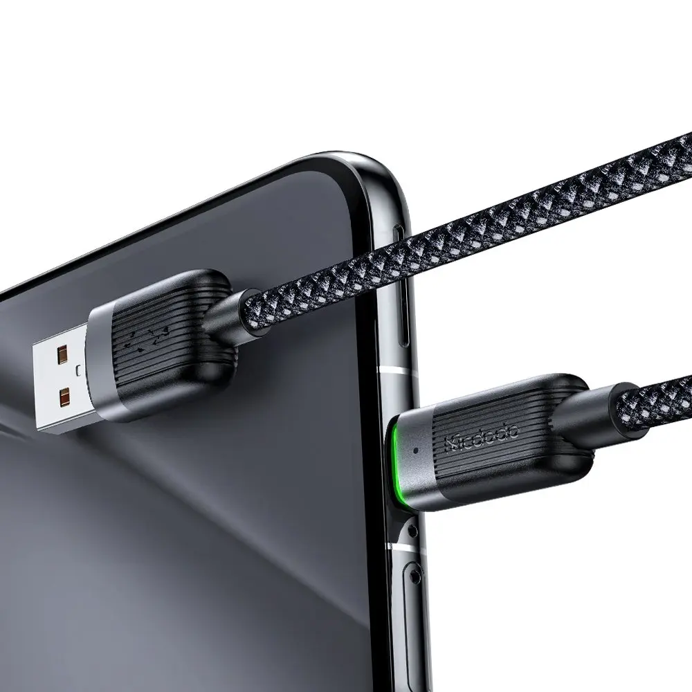 Örgülü desenli siyah bir USB kablosu bir akıllı telefona takılı.