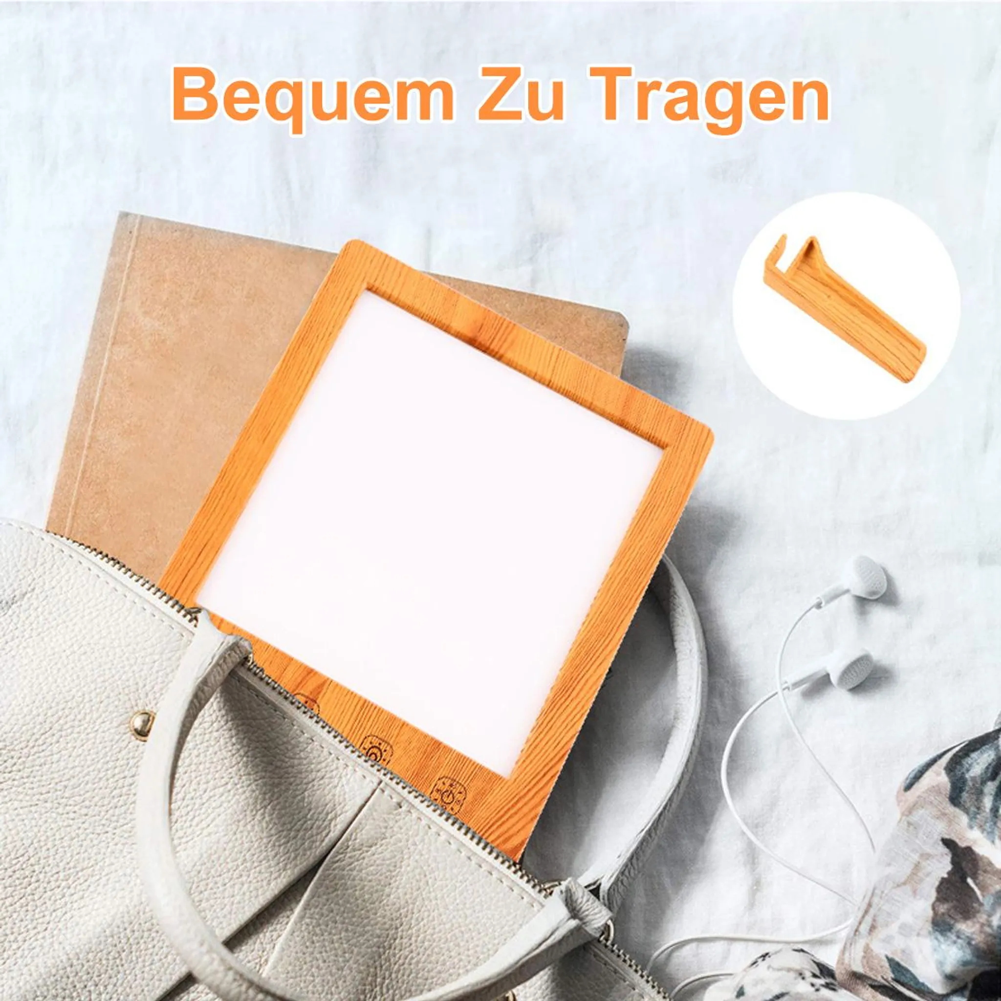 Weiße Handtasche mit Holzrahmen-Lampe, Buch und Kopfhörern.