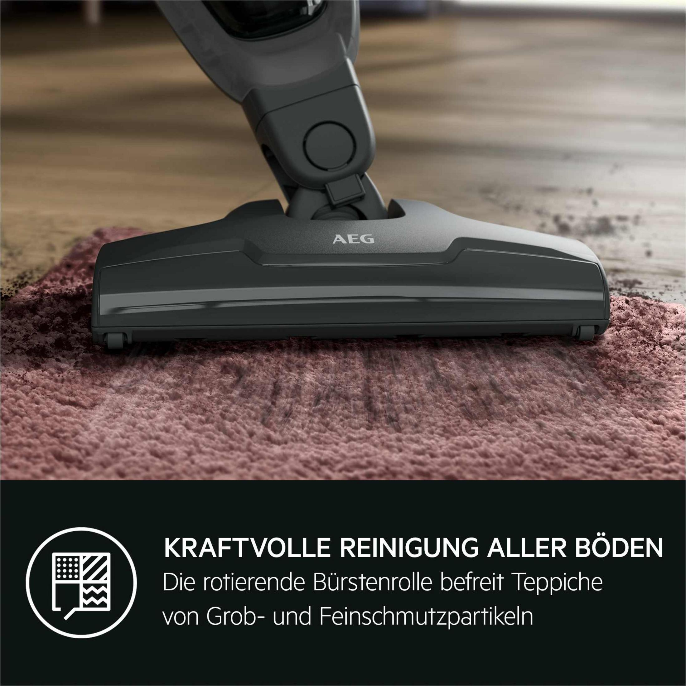 Ein dunkler AEG Staubsaugeraufsatz reinigt einen rosafarbenen Teppich.
