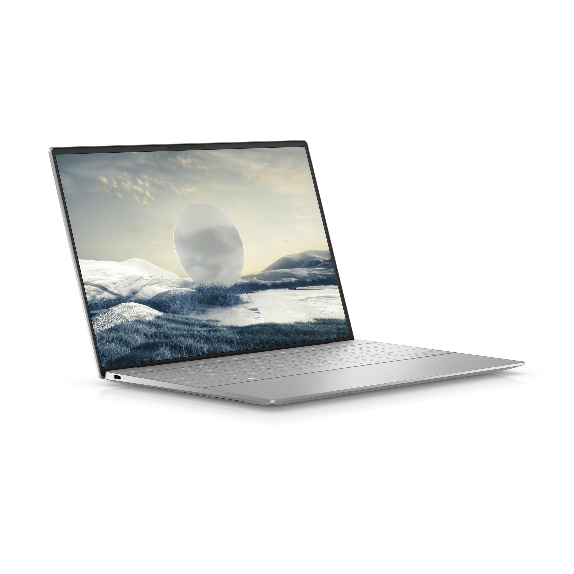 Ein silberner Laptop mit einem verschneiten Landschaftsbildschirm.