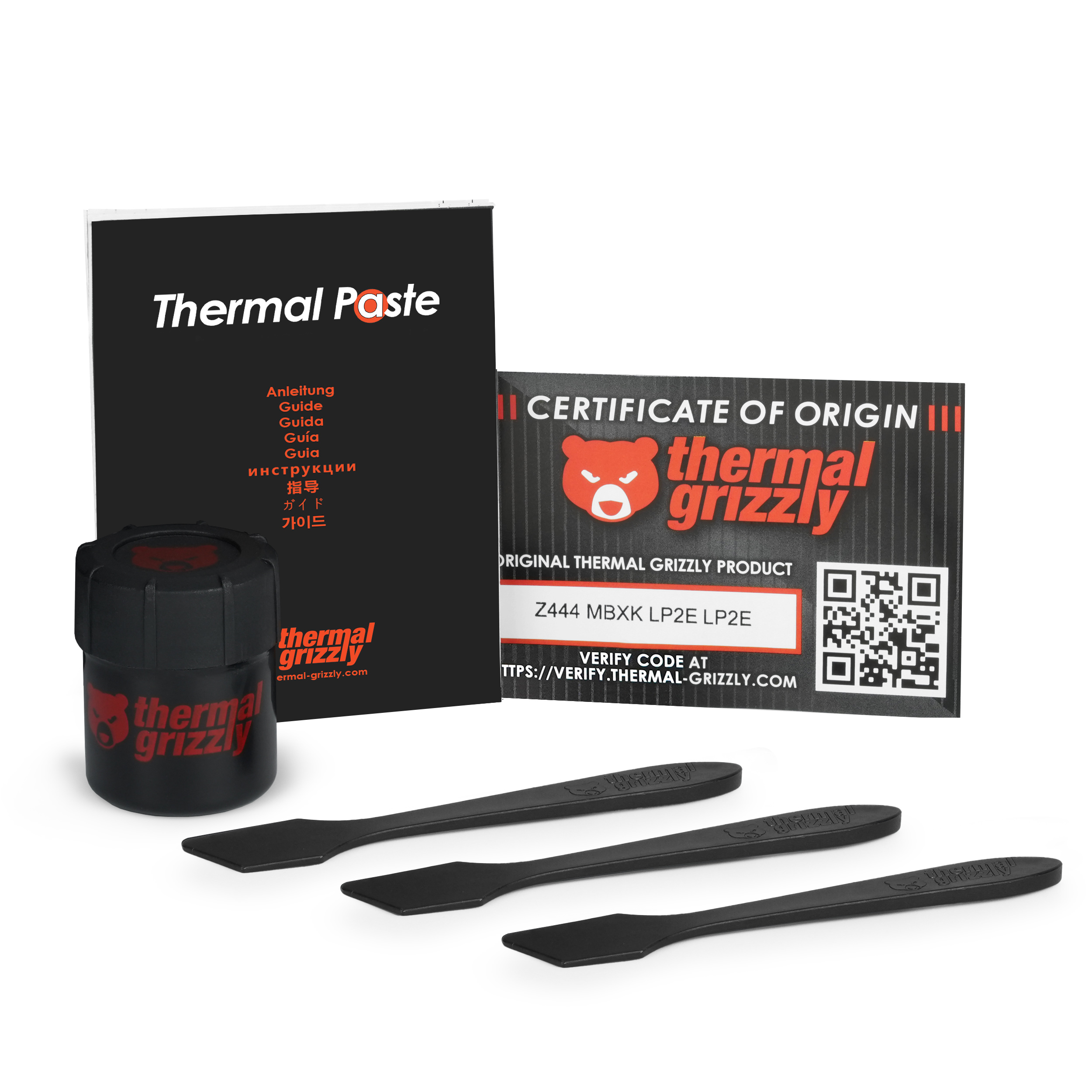 Thermal Grizzly Produkt mit Anleitung, Dose und drei Spateln.