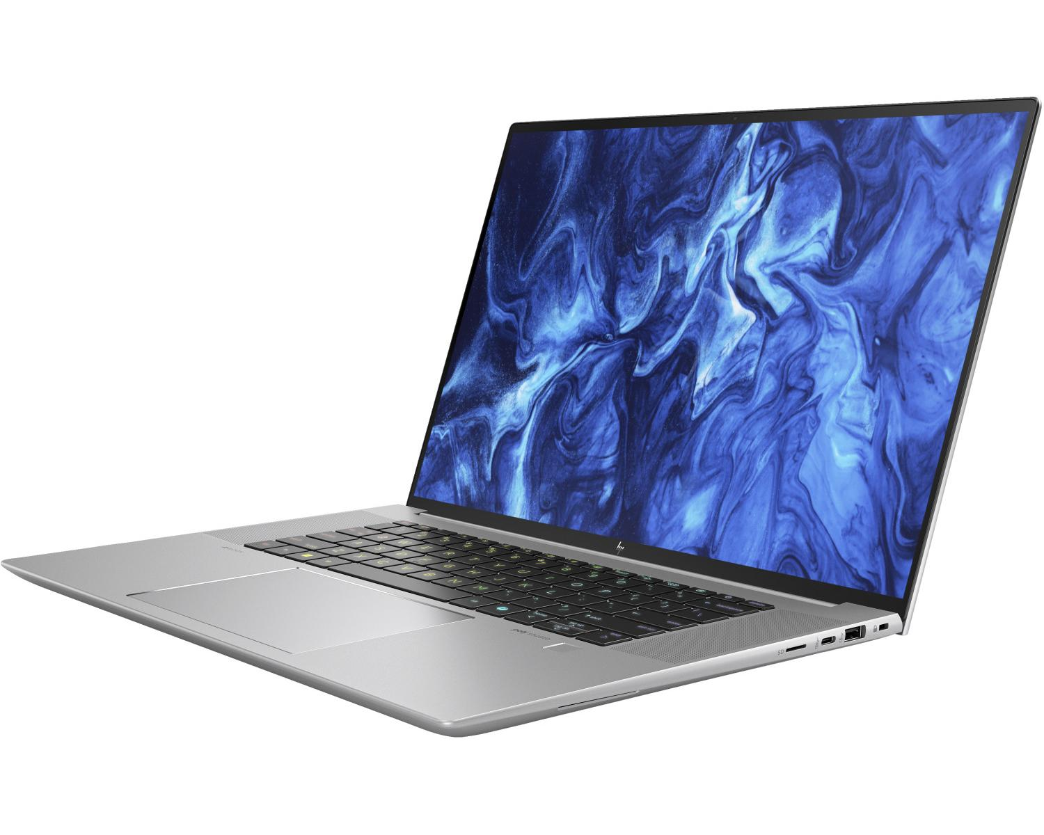 Un laptop argento con uno sfondo astratto blu sullo schermo.