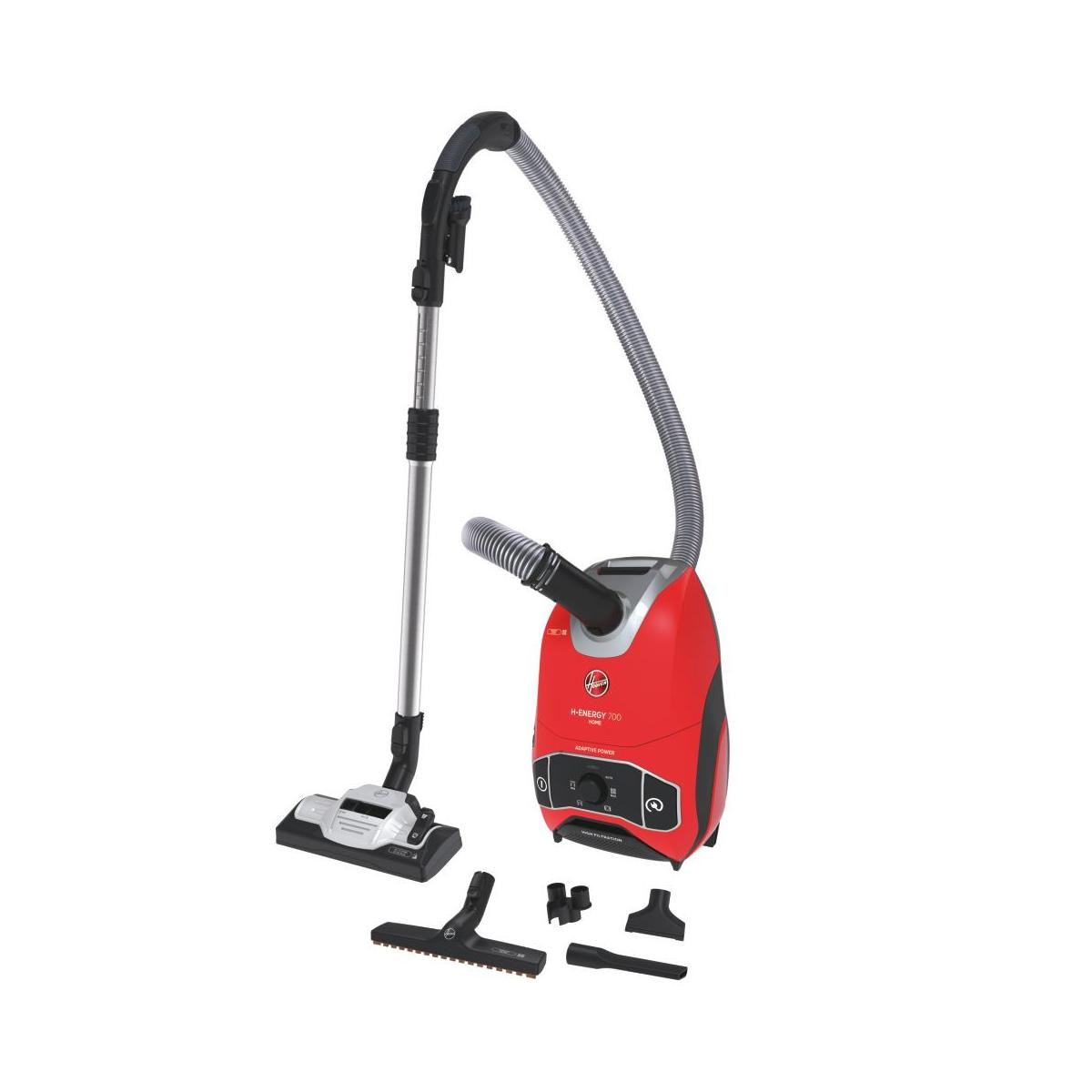 Un aspirapolvere Hoover rosso con tubo, lancia, spazzola e accessori.