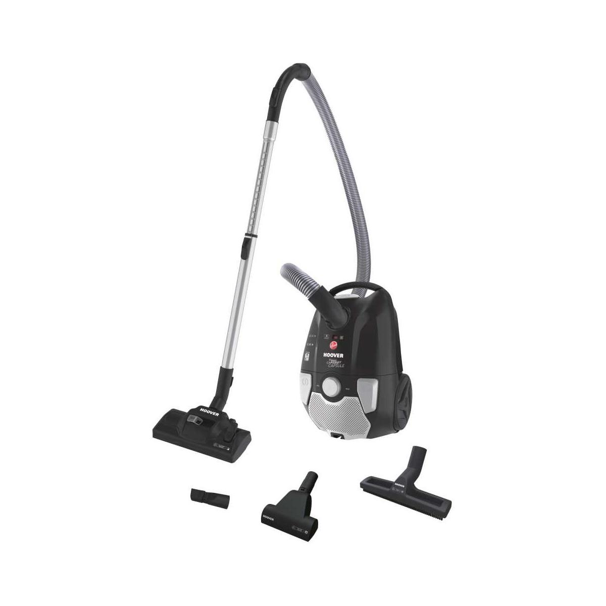 Aspirapolvere Hoover nero a traino con accessori su sfondo bianco.