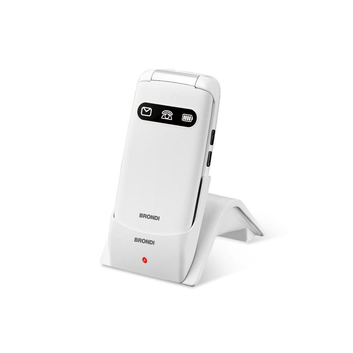 Un telefono a conchiglia bianco su una base di ricarica con logo Brondi.