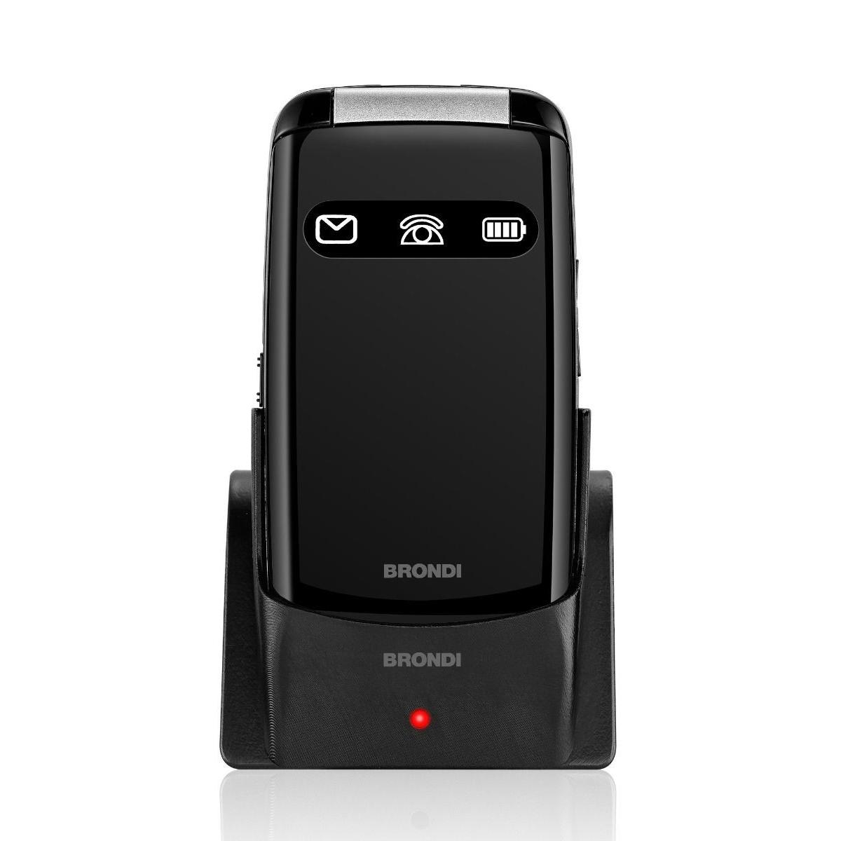 Teléfono plegable negro con base de carga, muestra iconos de mensajes, llamadas y batería.