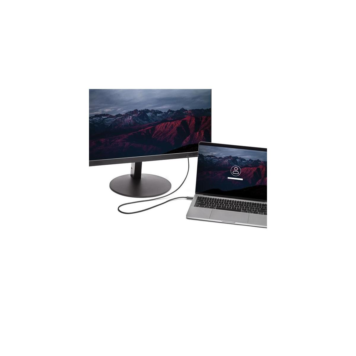 Un monitor y un portátil con paisajes de montaña en las pantallas, conectados por un cable.