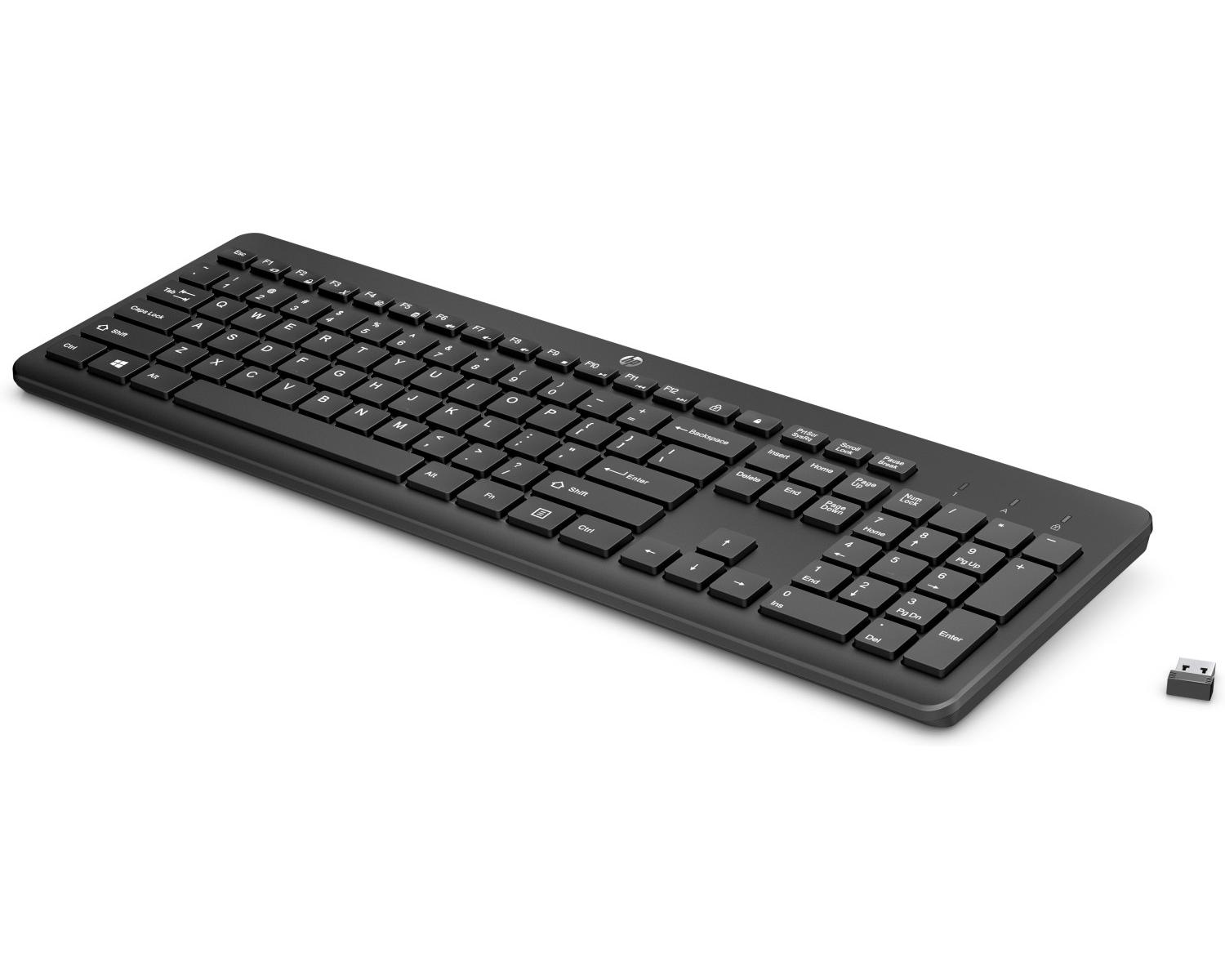 Schwarze Tastatur mit separatem USB-Empfänger auf weißem Hintergrund.
