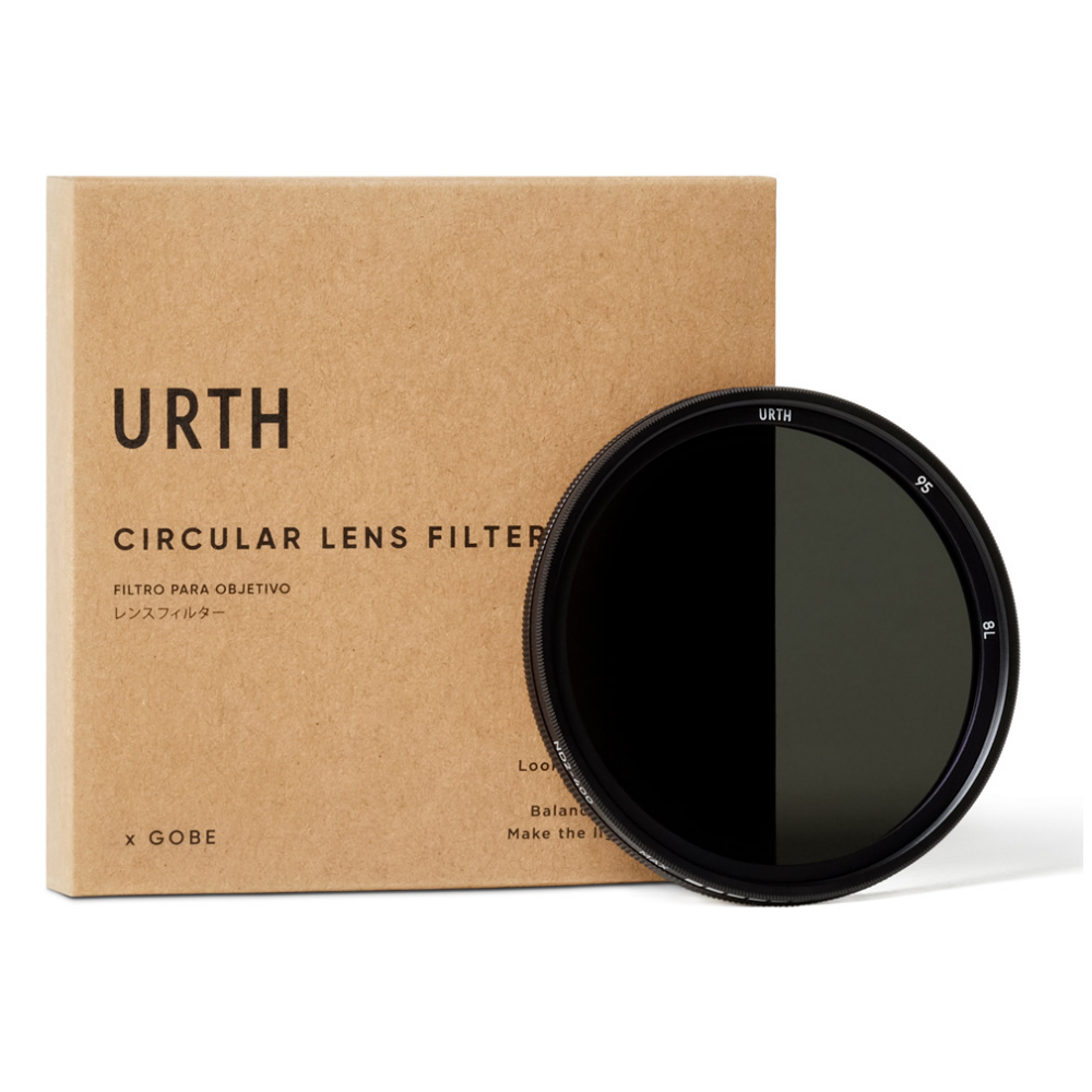 Een URTH cirkelvormig lensfilter en een bruine doos met 'URTH' erop.