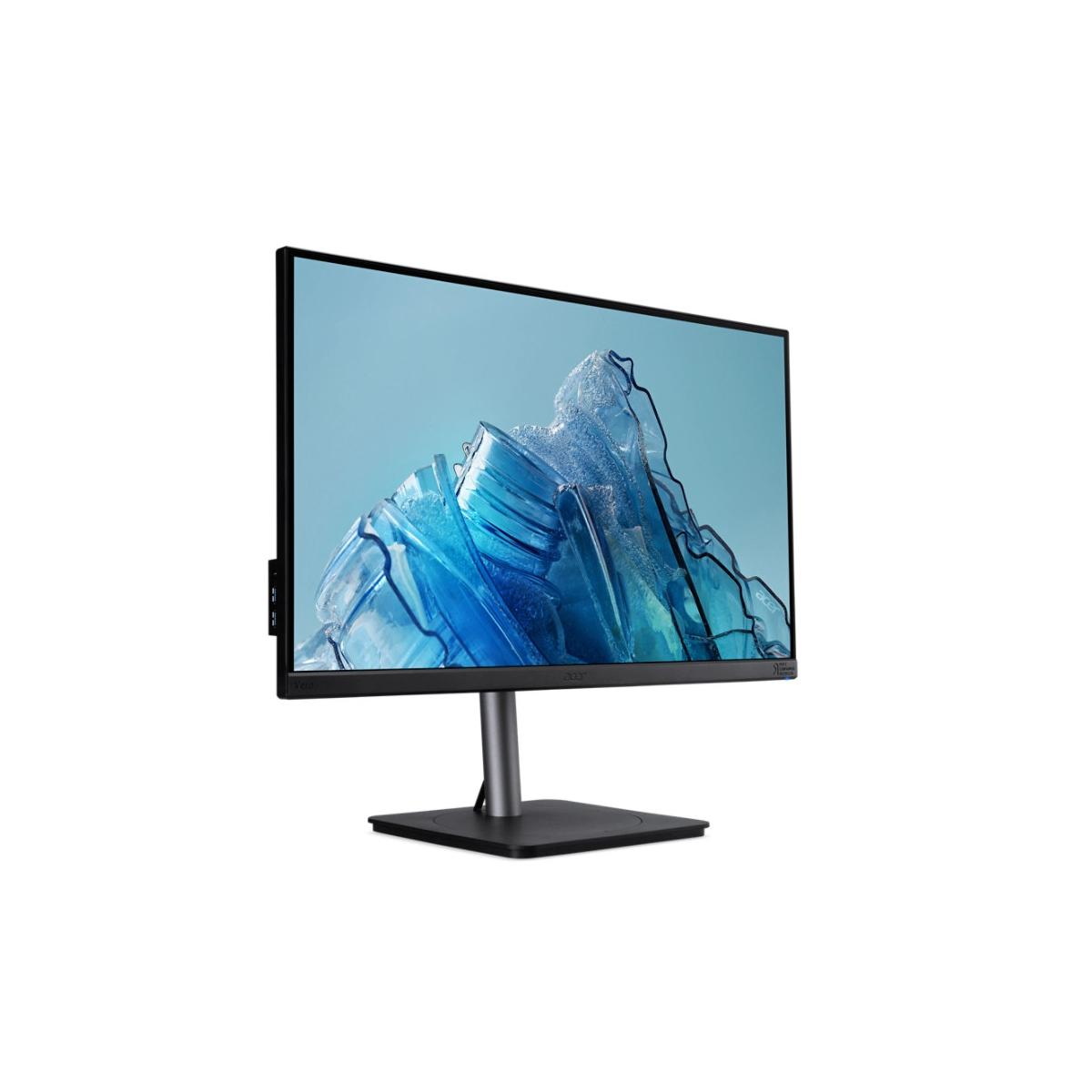 A modern computer monitor displaying a blue iceberg wallpaper.
