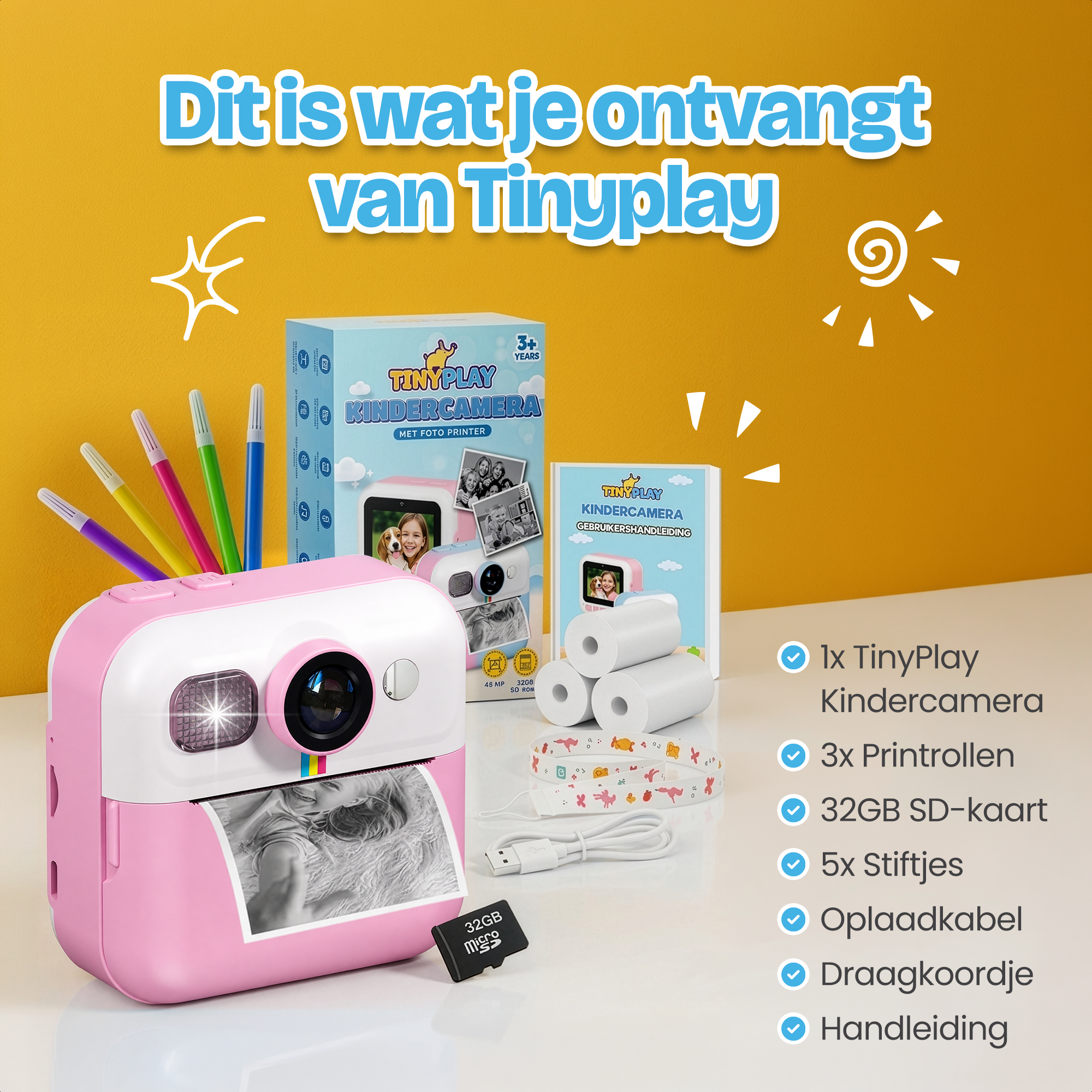 Een roze TinyPlay kindercamera set met pennen, rollen, kabel en SD-kaart.