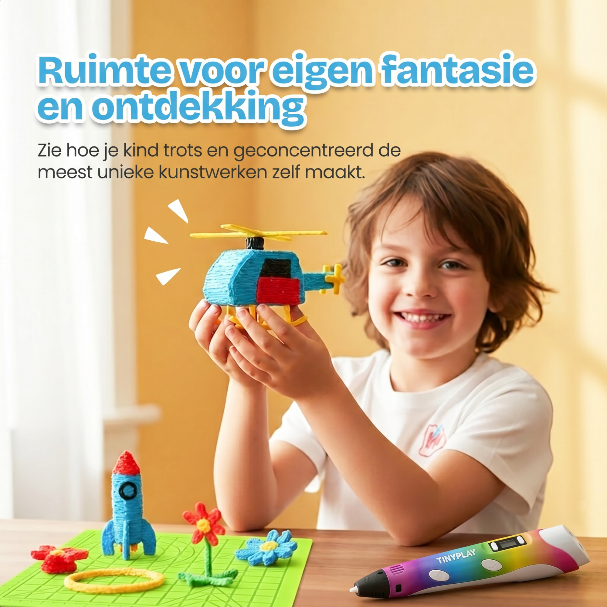 Jongen houdt een 3D-geprinte helikopter vast. Een raket, bloemen en ring liggen voor hem.