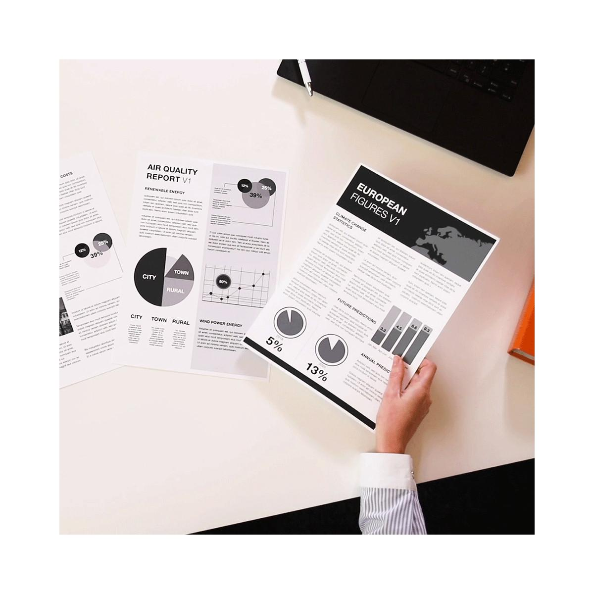 Hand holding report with charts: European figures, air quality, wind power.
