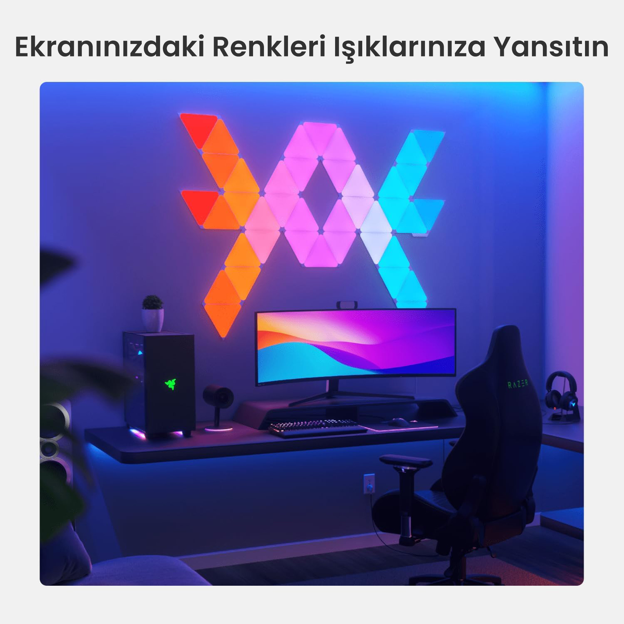 Una postazione da gioco con scrivania, sedia, computer e design a parete illuminato.
