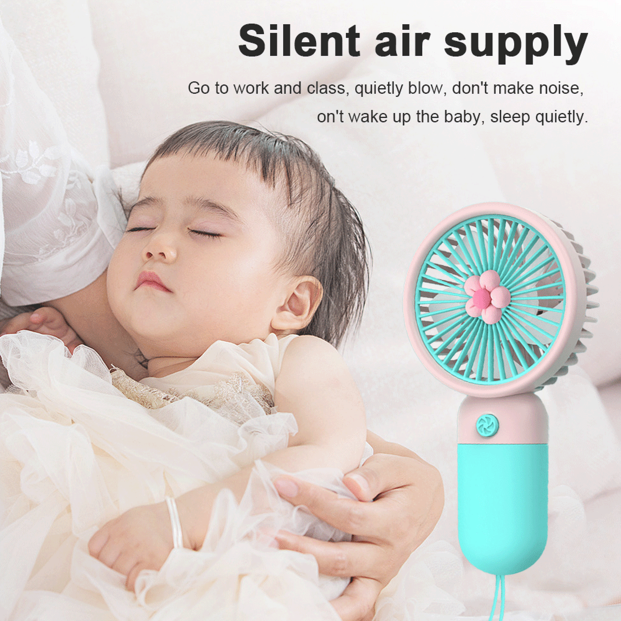 Ein schlafendes Baby wird gehalten, ein pinker und blauer tragbarer Ventilator daneben.