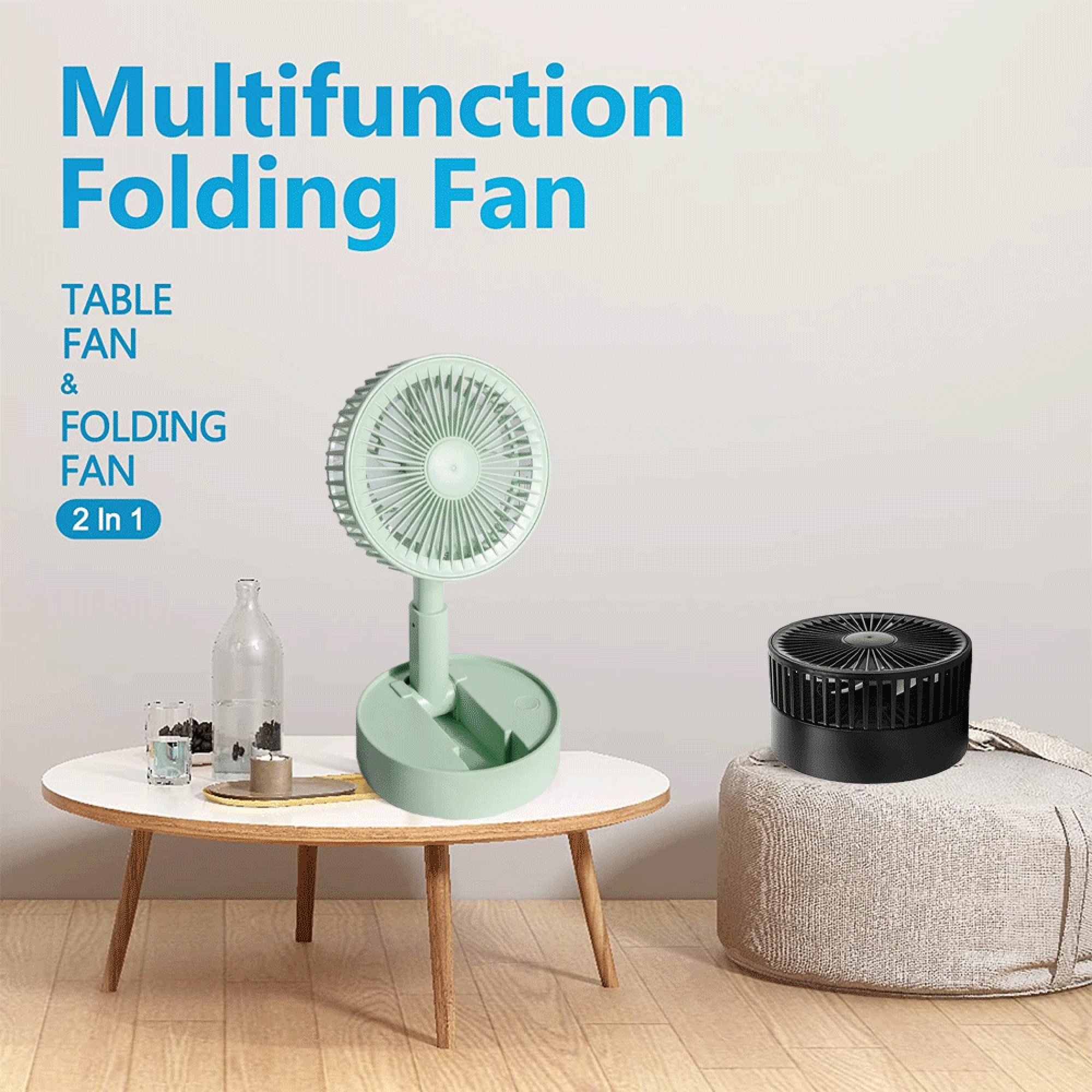 Ein aufklappbarer Ventilator in Mintgrün steht auf einem Tisch neben einem schwarzen Ventilator.
