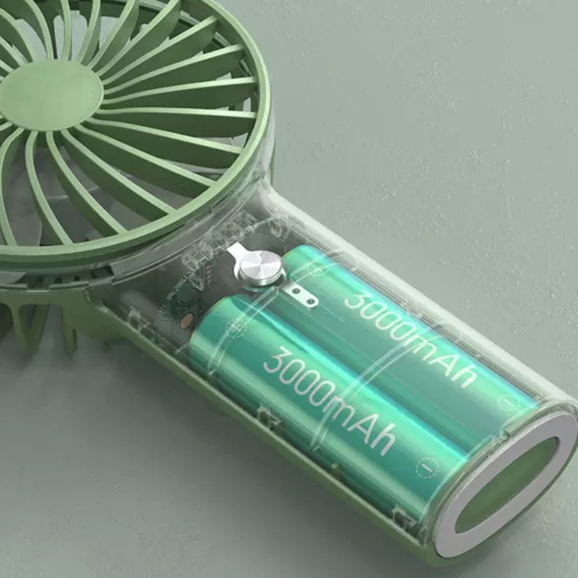 Ein grüner Handventilator mit durchsichtigem Gehäuse, der zwei 3000-mAh-Akkus zeigt.