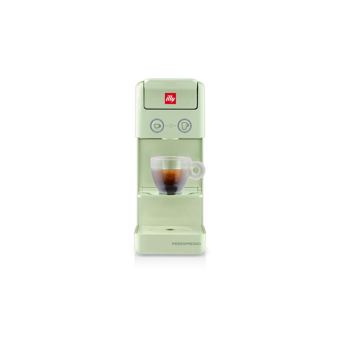 Una máquina Illy iperEspresso verde pálido con un shot de espresso en vaso.