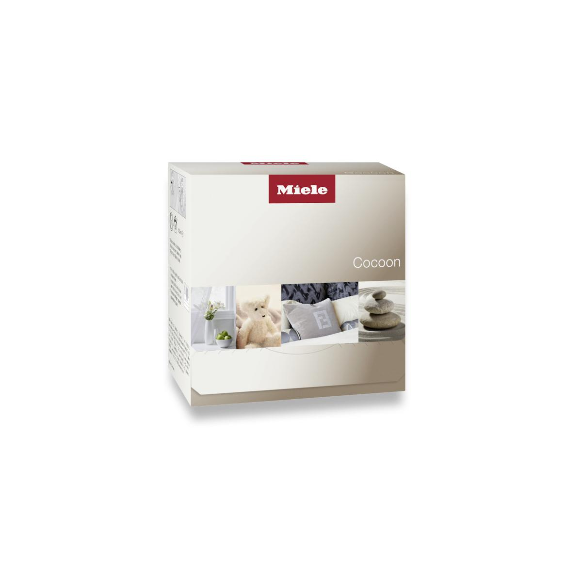 Miele Cocoon Verpackung mit Bildern eines Teddybären, Kissen und Steinen.