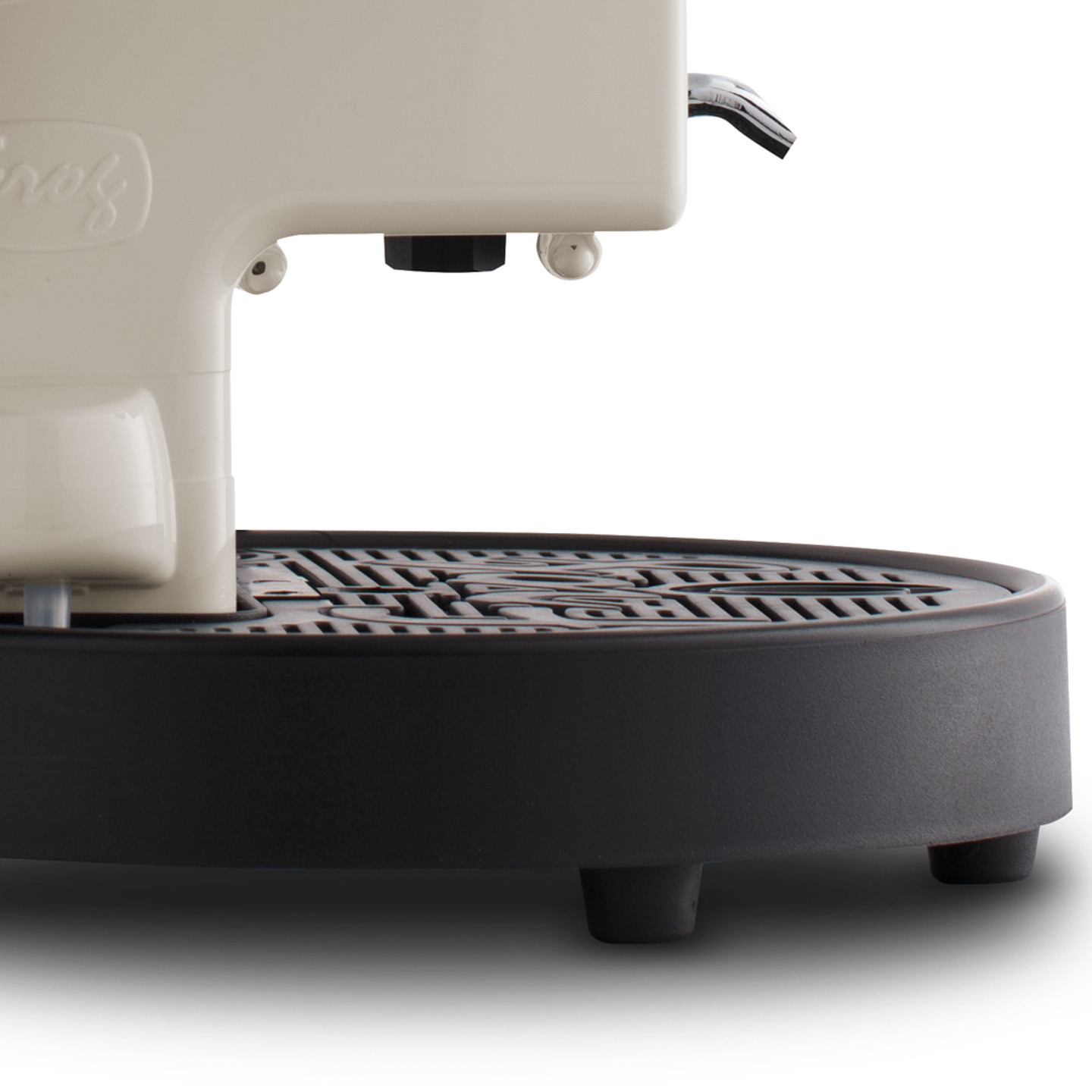 Close-up of a cream-colored coffee machine with a black drip tray and three feet.