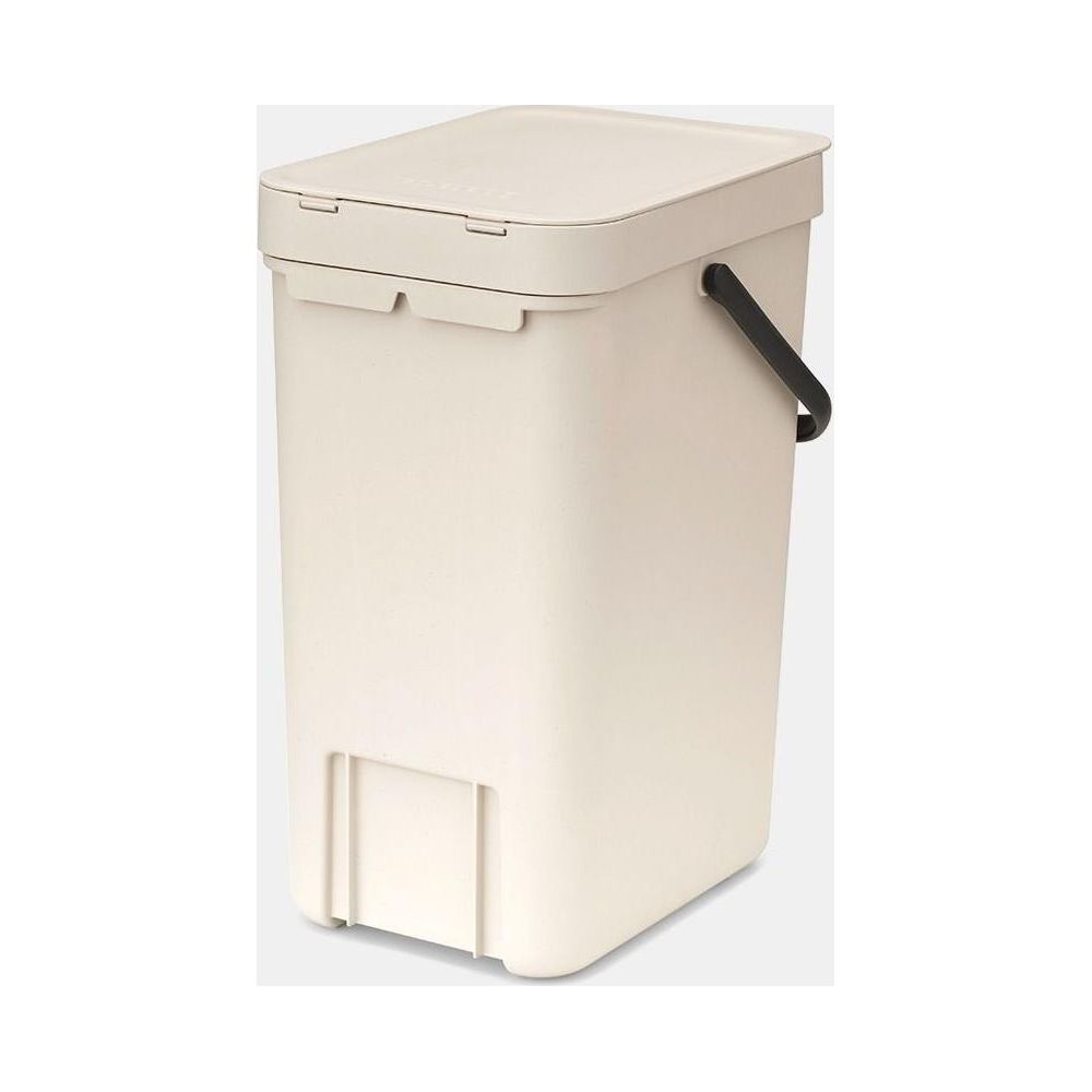 Een crème-kleurige compostbak met een zwart handvat en deksel.