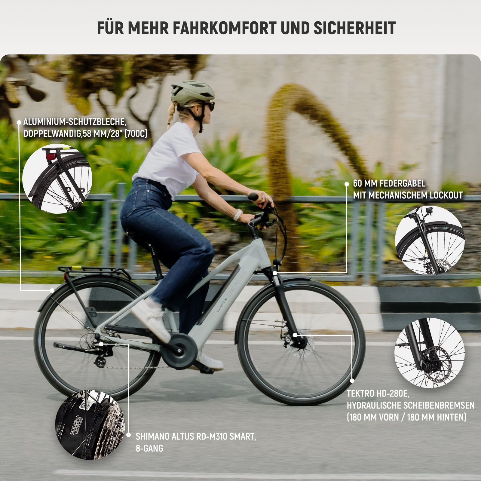 Frau fährt hellgraues E-Bike mit Schutzblechen, Federgabel und Scheibenbremsen.