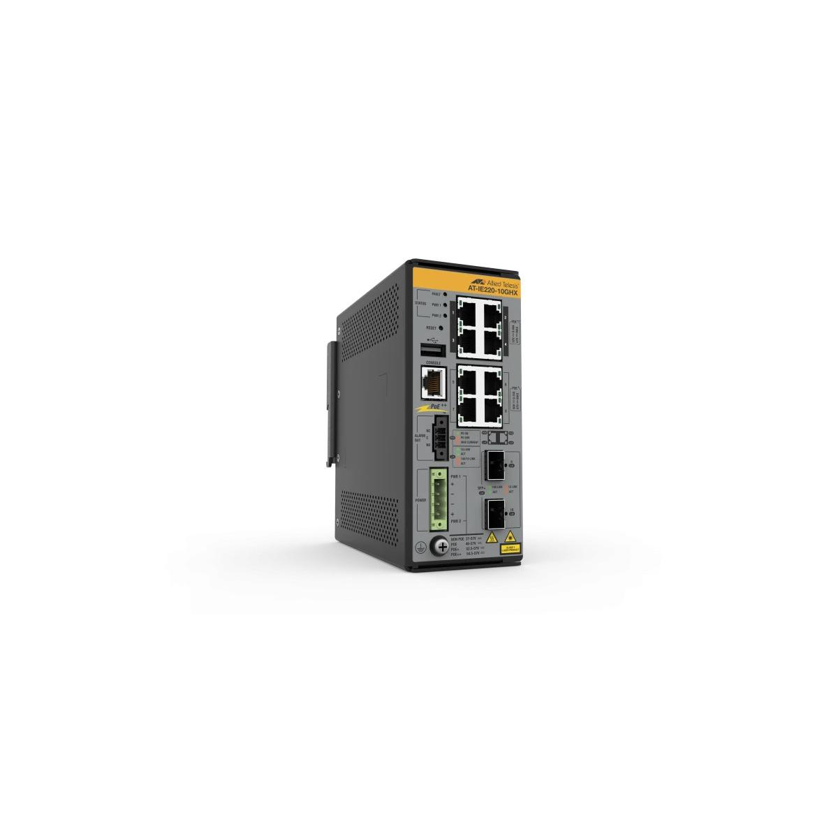 Switch di rete grigio con parte superiore gialla, quattro porte Ethernet sopra, due sotto.