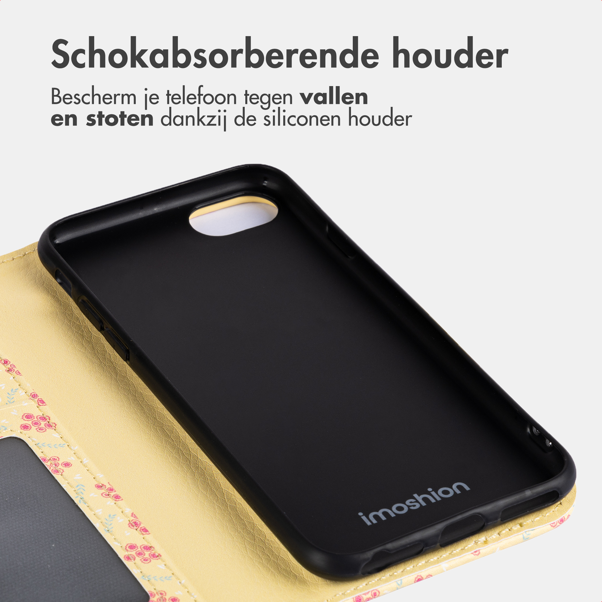 Une coque de téléphone noire à motif floral jaune. Texte en néerlandais.