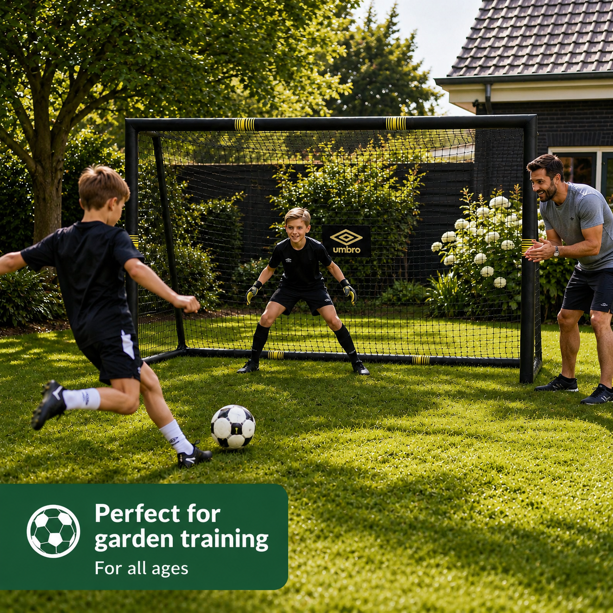 Boys play soccer in a garden, one kicks, one defends. Father watches.