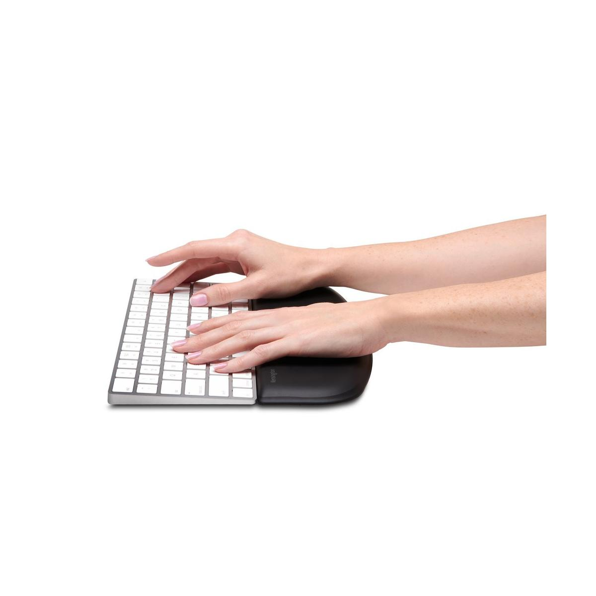 Hands on a keyboard with wrist rest, white keys, white background.