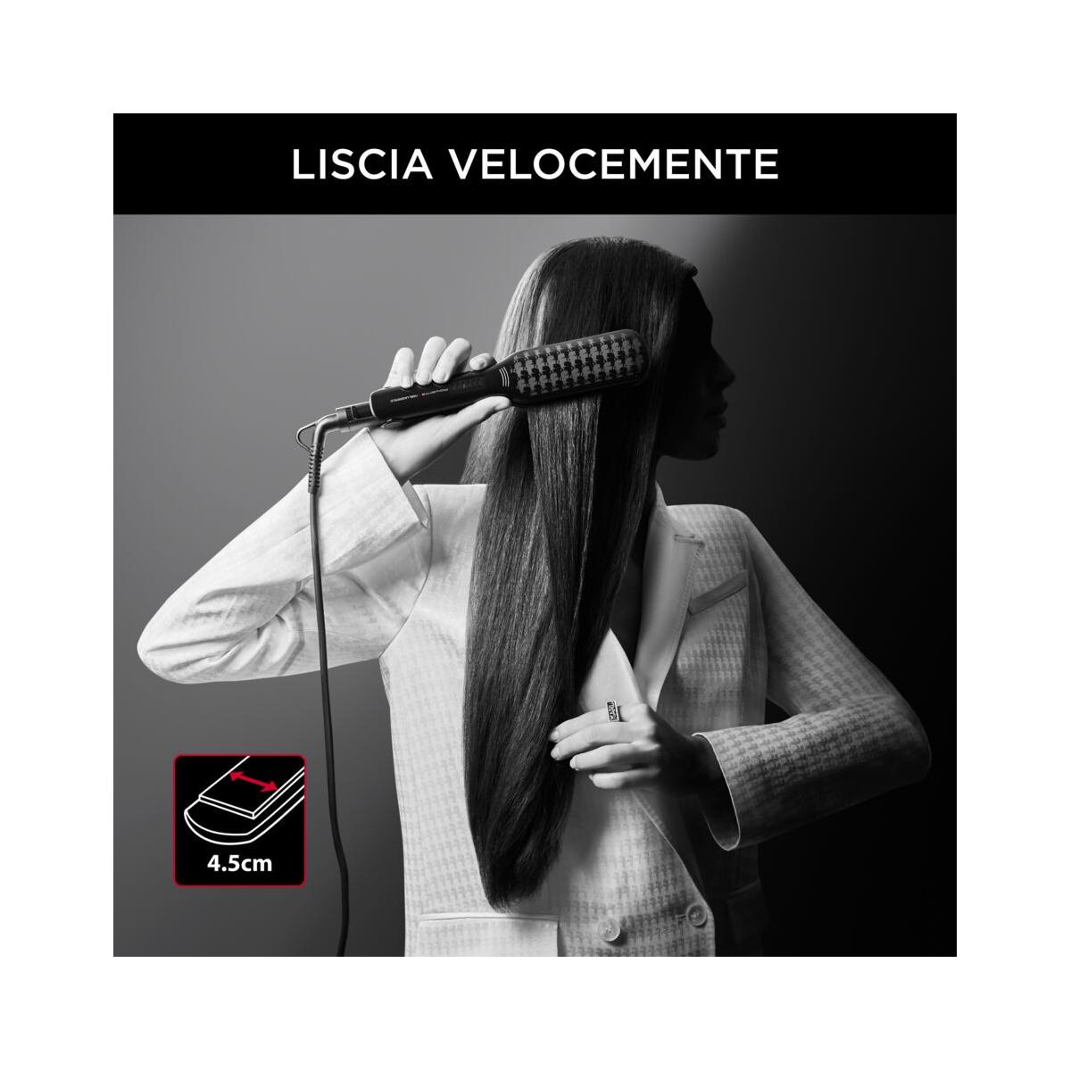 Woman straightening her long hair with an electric comb. 4.5cm.