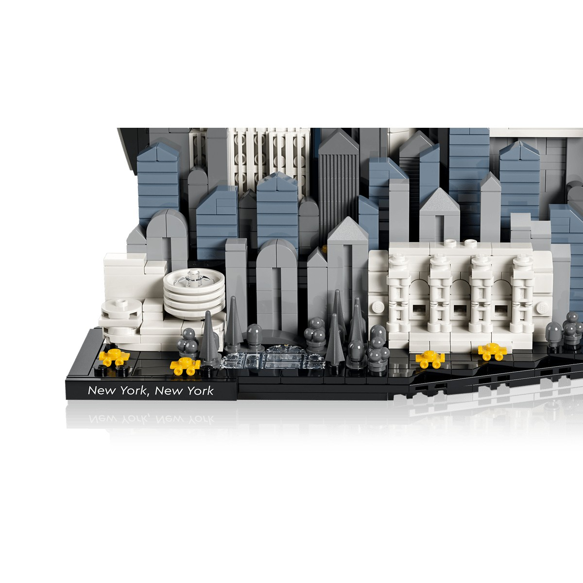 Modelo Lego del horizonte de Nueva York con rascacielos, taxis amarillos y árboles.