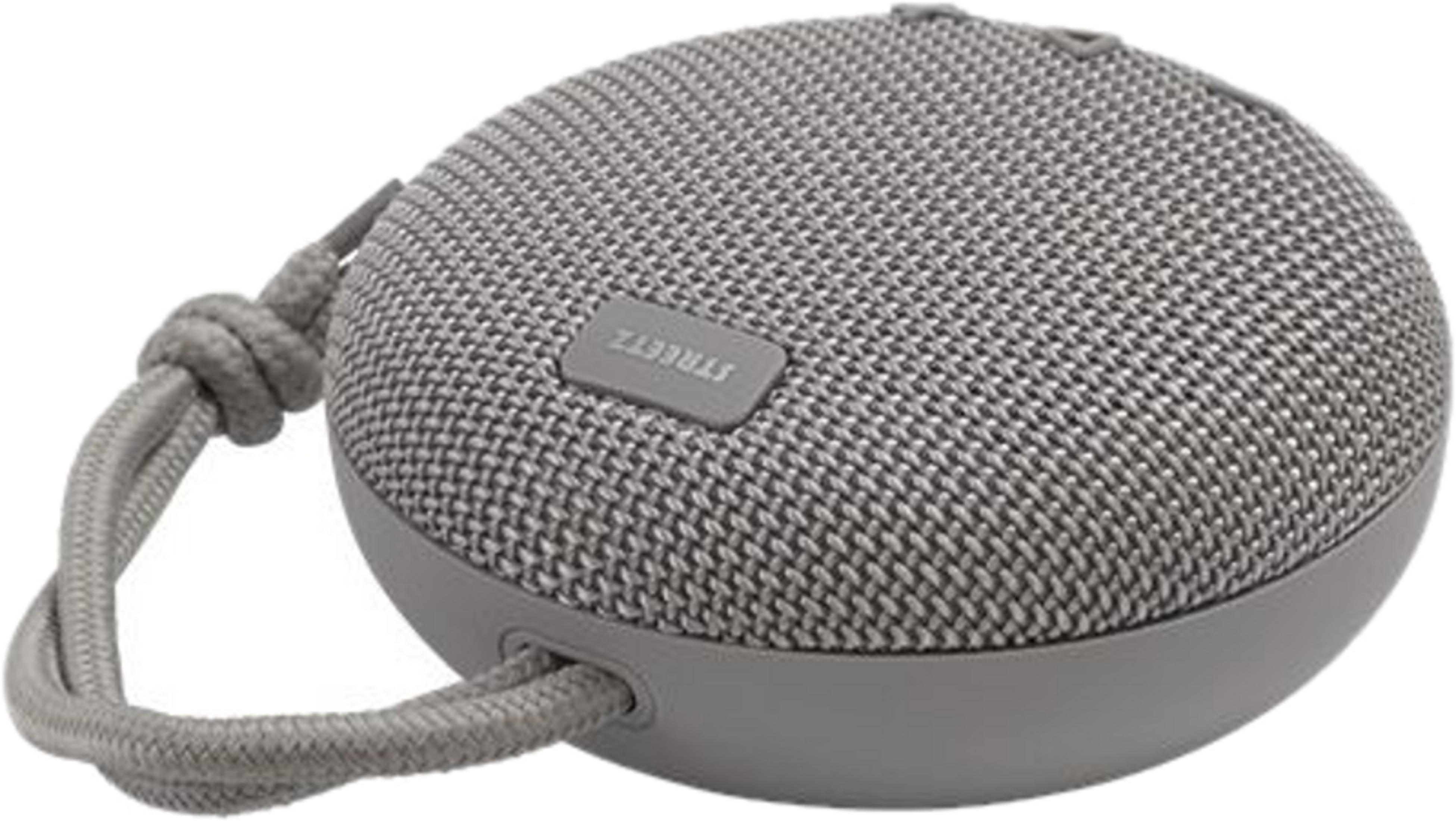 Altoparlante Bluetooth ovale grigio con griglia in tessuto e cinghia.
