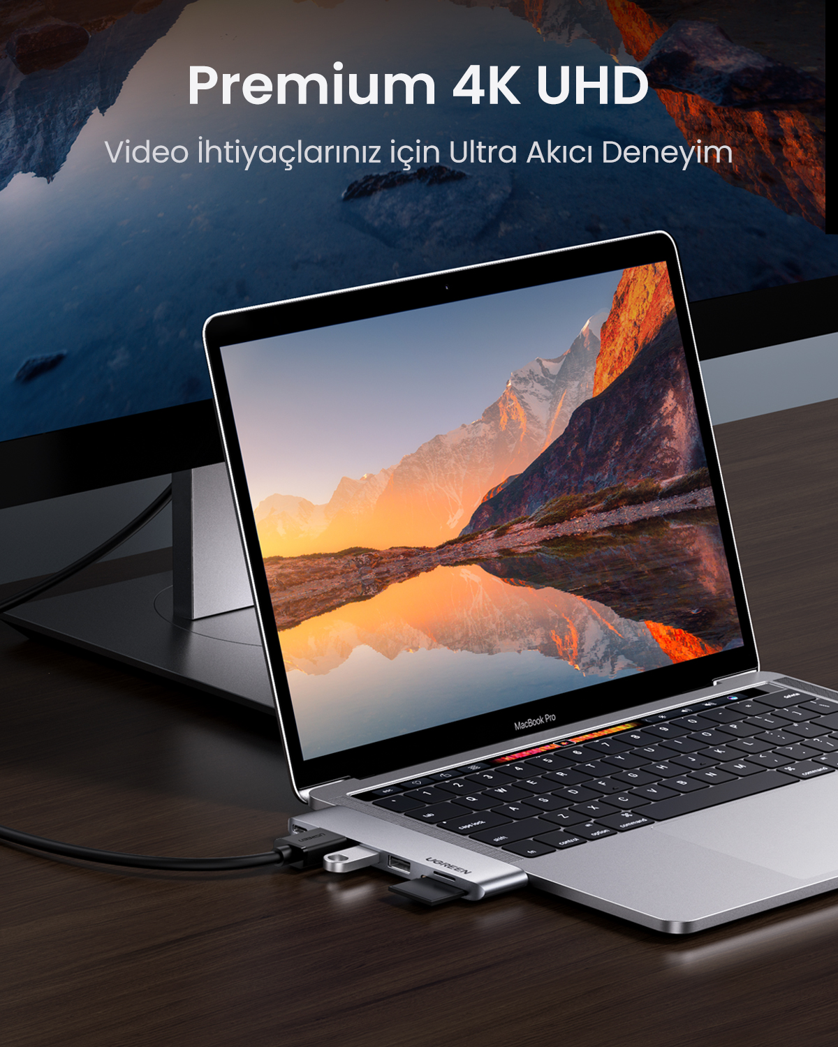 Yan tarafına USB-C hub takılı bir dizüstü bilgisayar. Ekranda dağ manzarası.